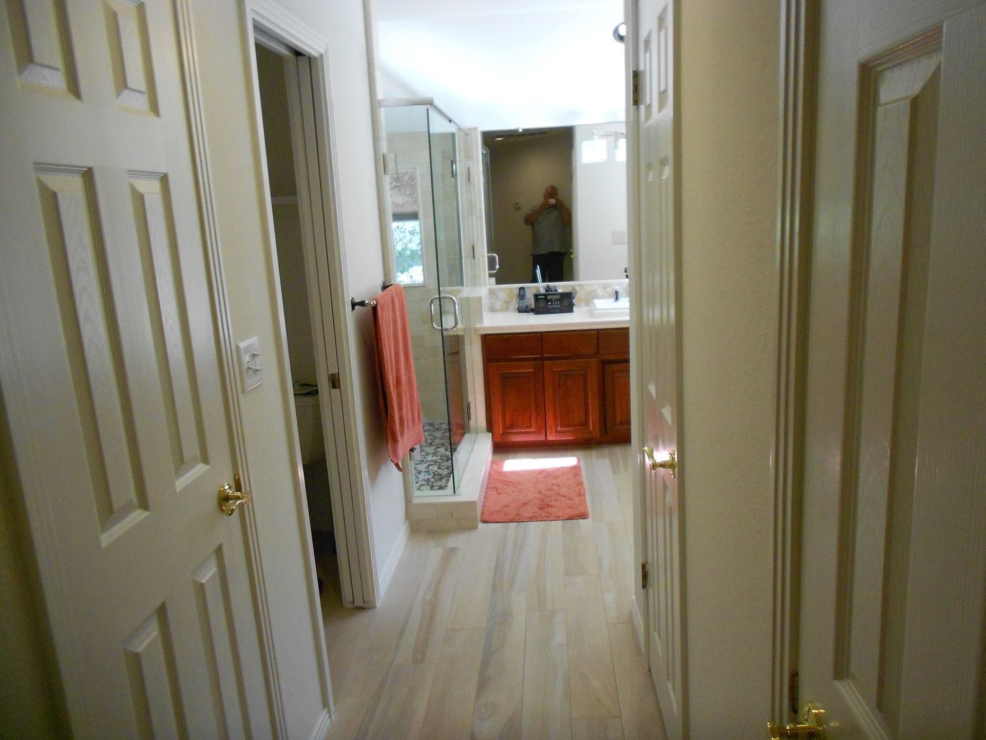 A bathroom with two sinks and a walk in shower