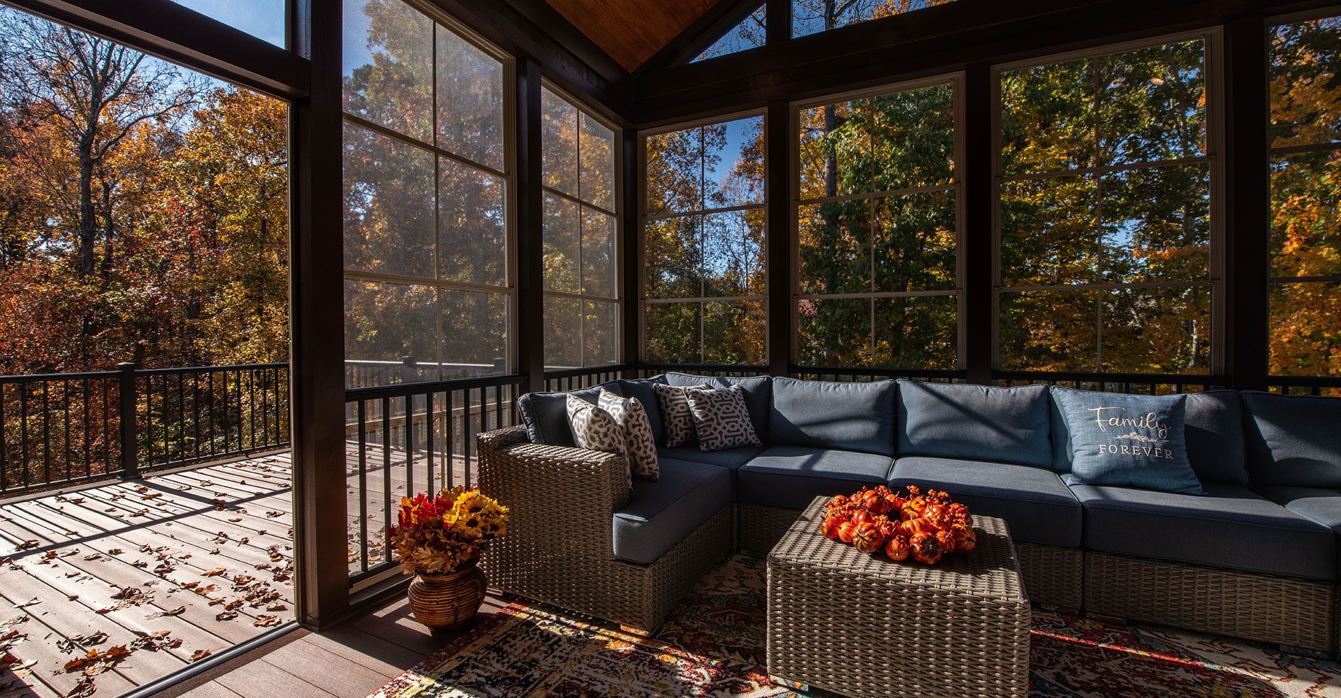 A screened in porch with a couch and a table