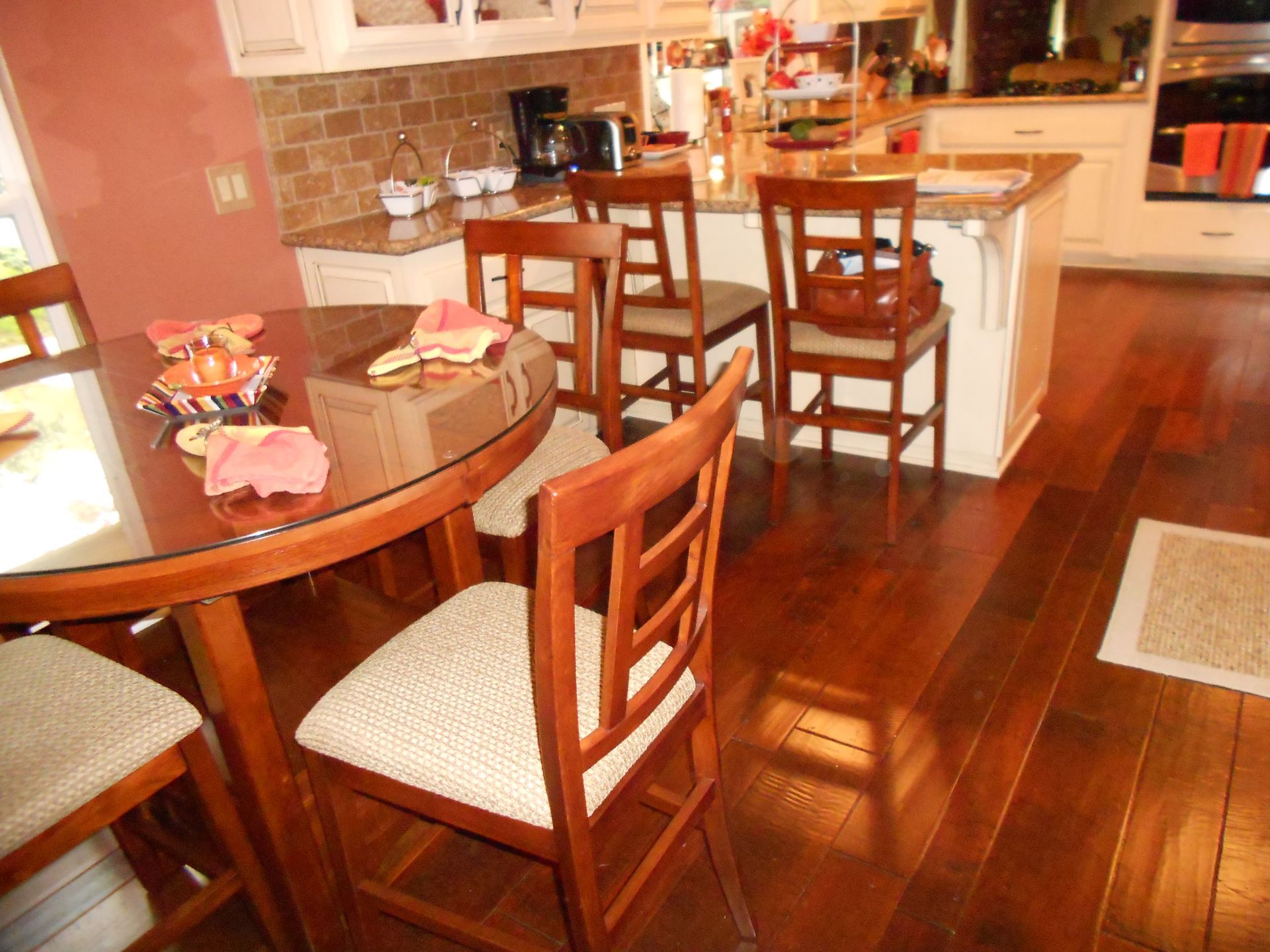 A kitchen with a table and chairs in it