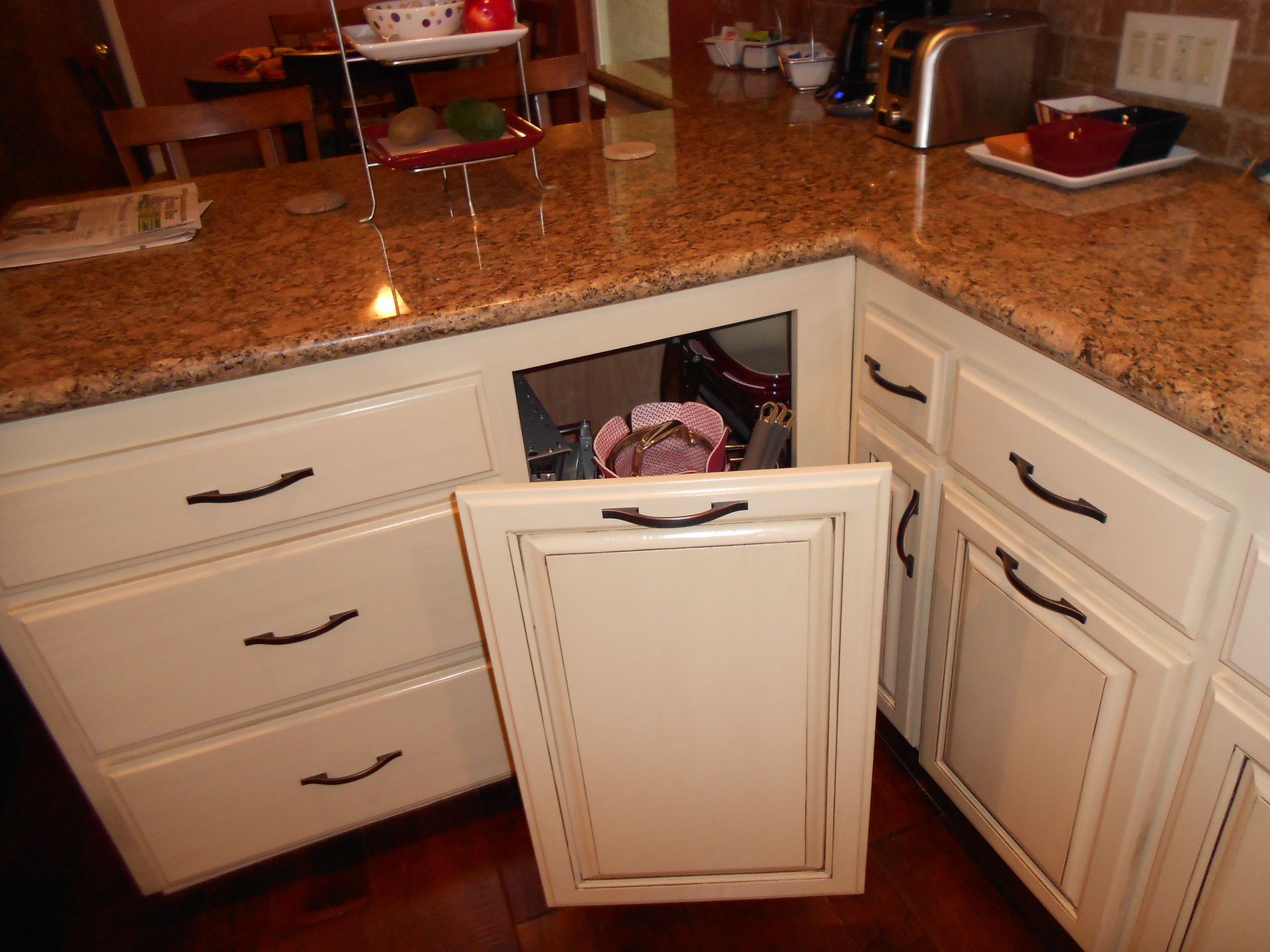 A kitchen with white cabinets and granite counter tops