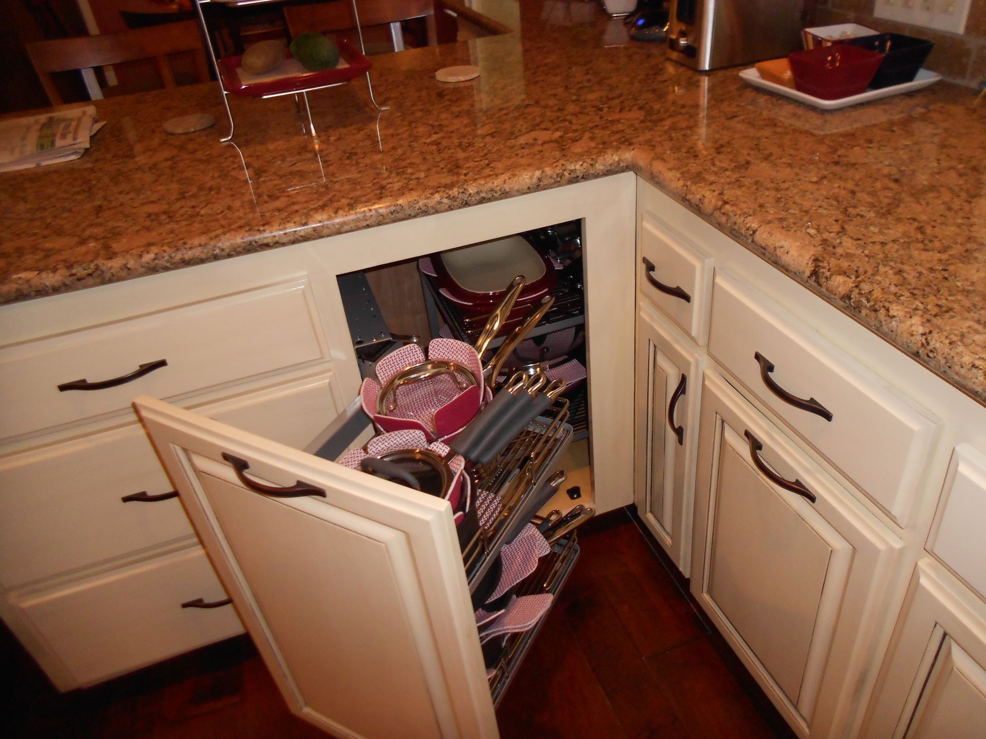A kitchen with white cabinets and granite counter tops
