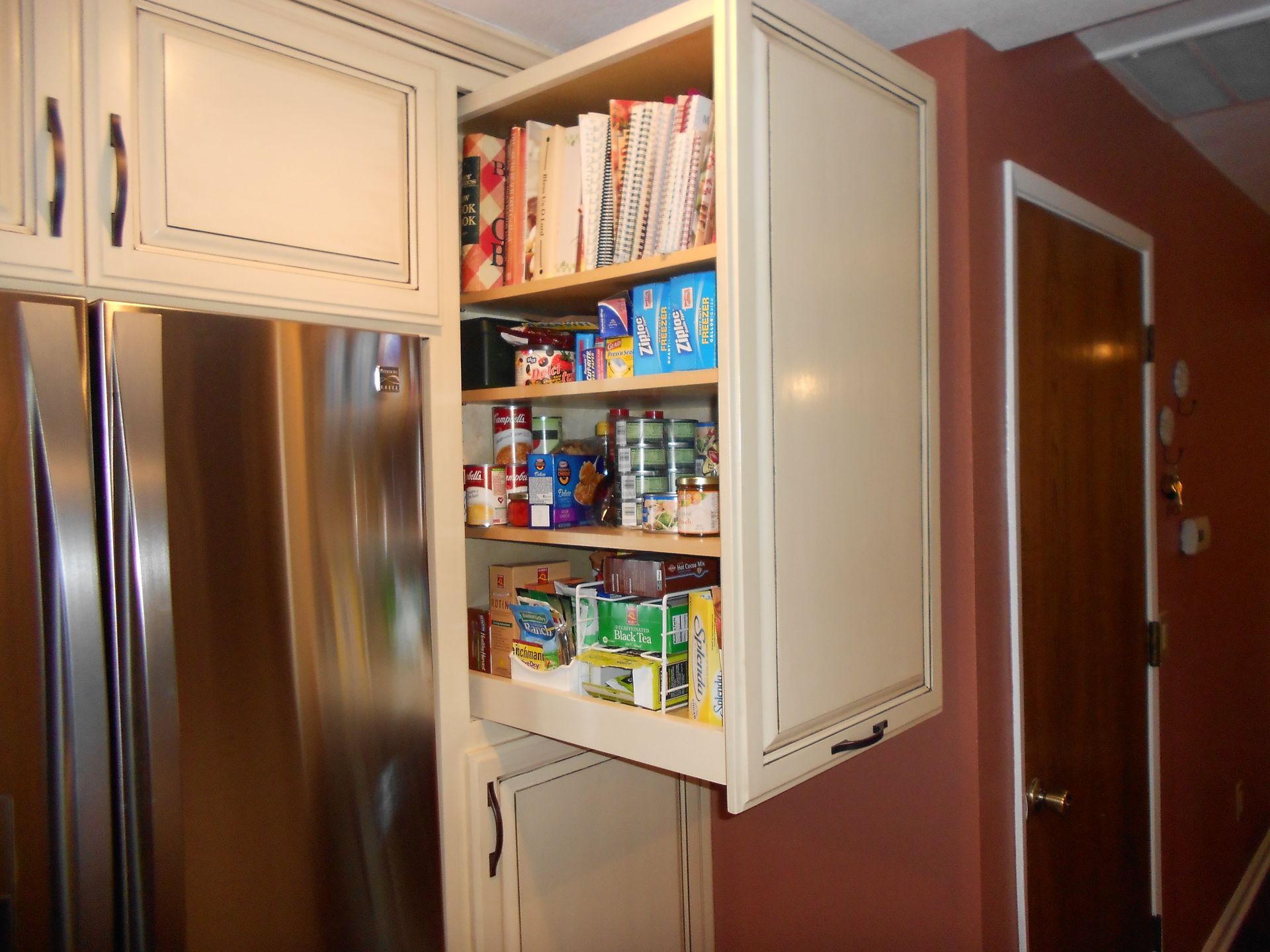 A pantry in a kitchen with the door open