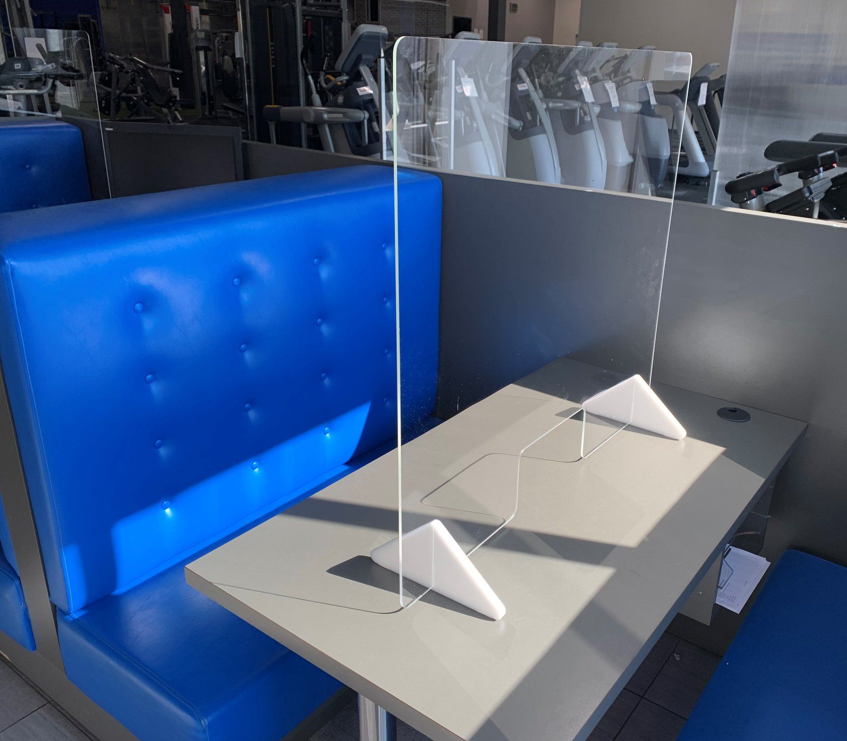 A table with a clear acrylic divider on it