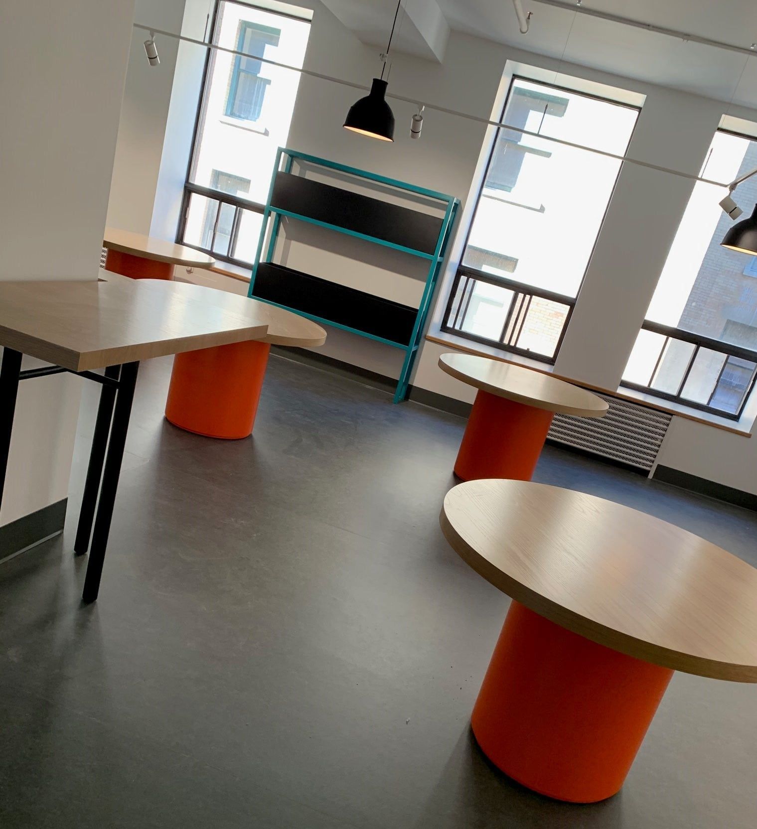 A room with a lot of windows and tables