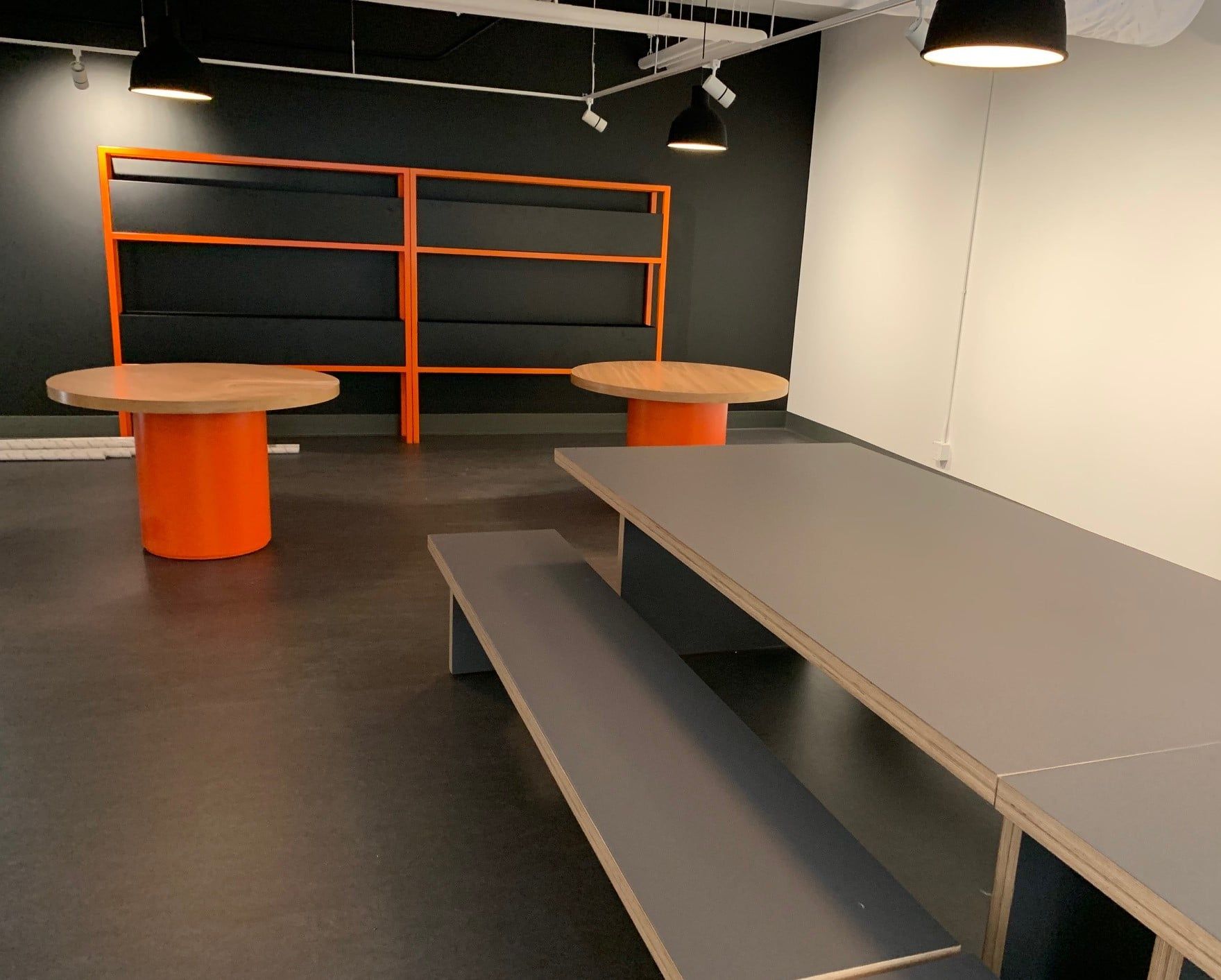 An empty room with two tables and a bench