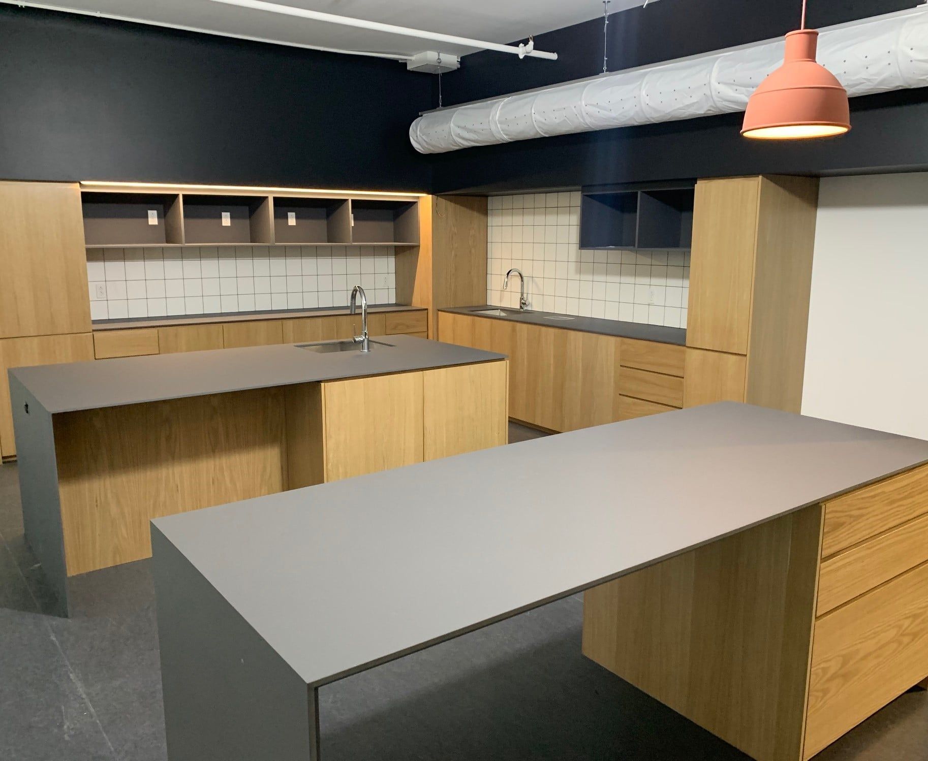 A kitchen with wooden cabinets and a large table