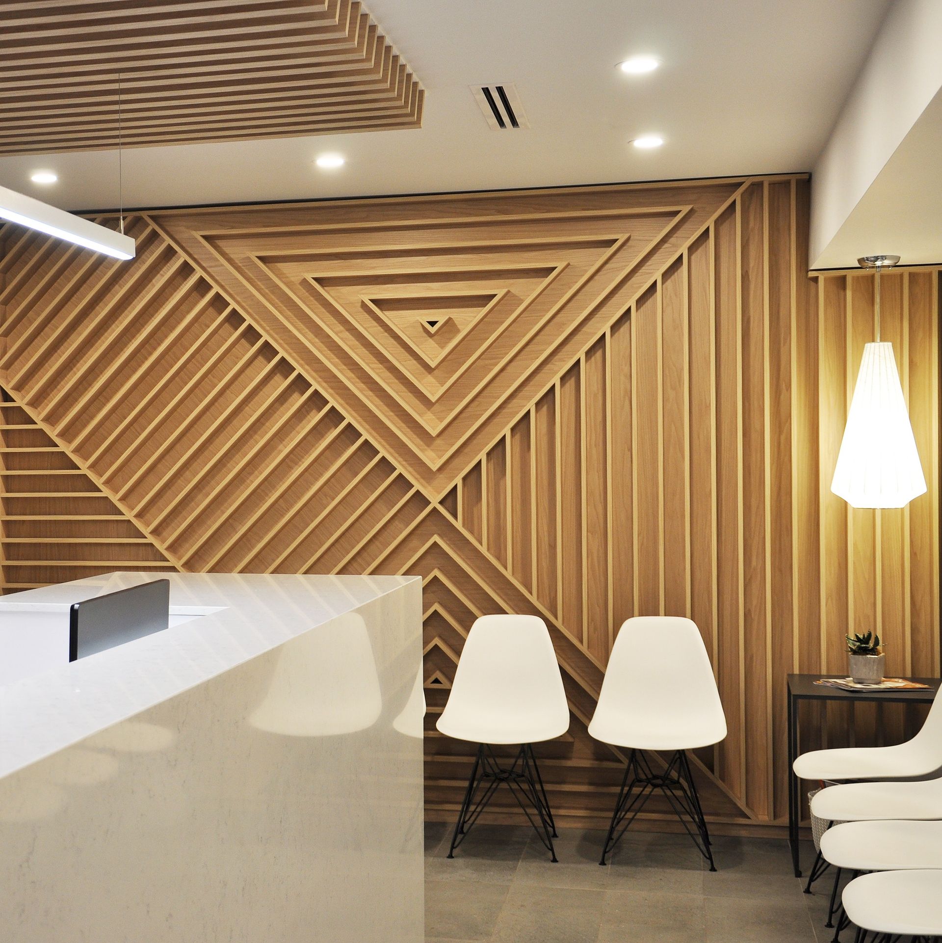 A waiting room with chairs and a wooden wall