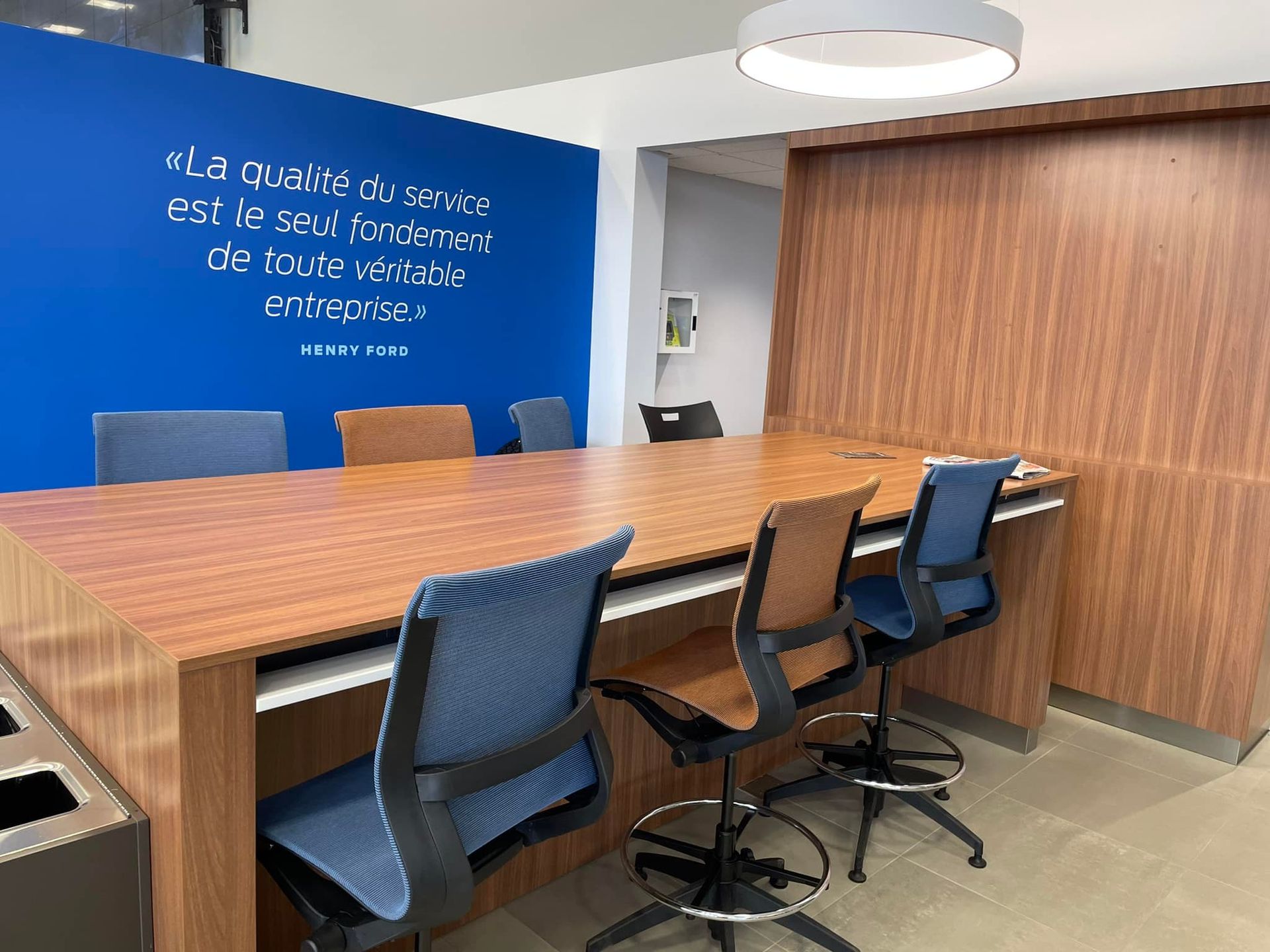 A conference room with a long wooden table and chairs.