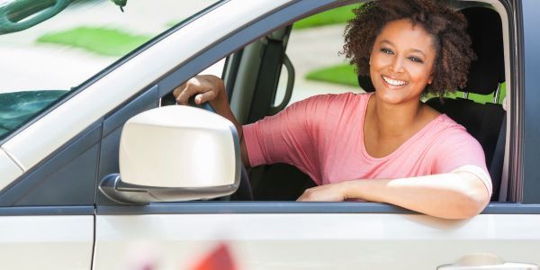 woman driving car with auto insurance