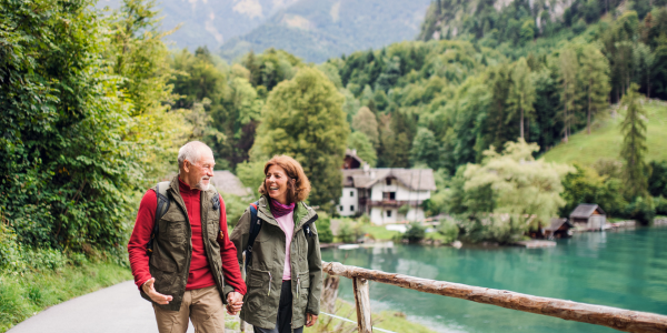 elderly couple walking outside talking about medicare