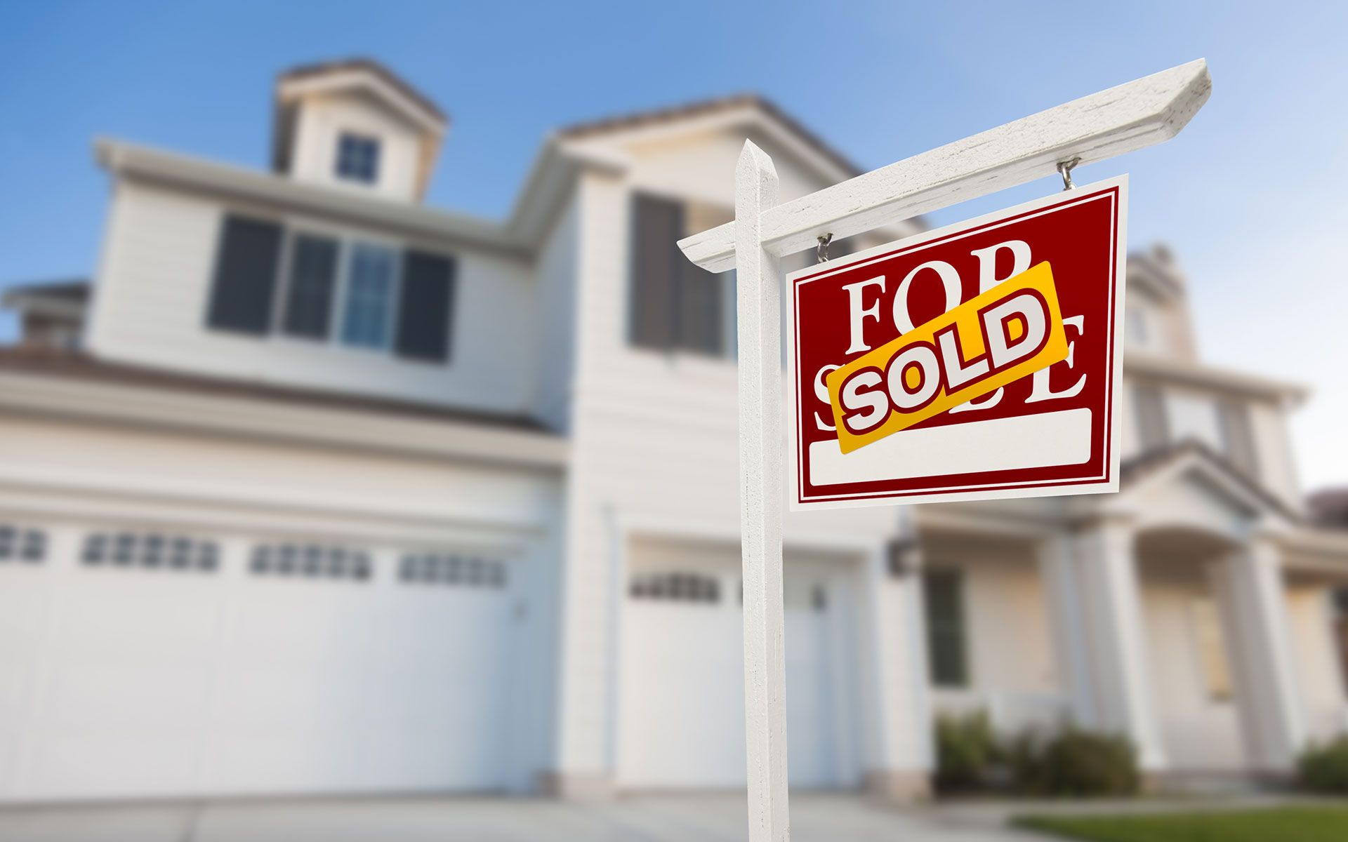 A for sale sign in front of a house