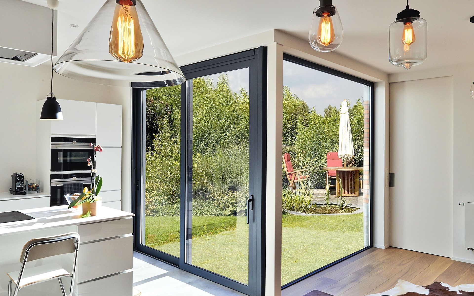 A kitchen and dining room with sliding glass doors leading to a backyard.