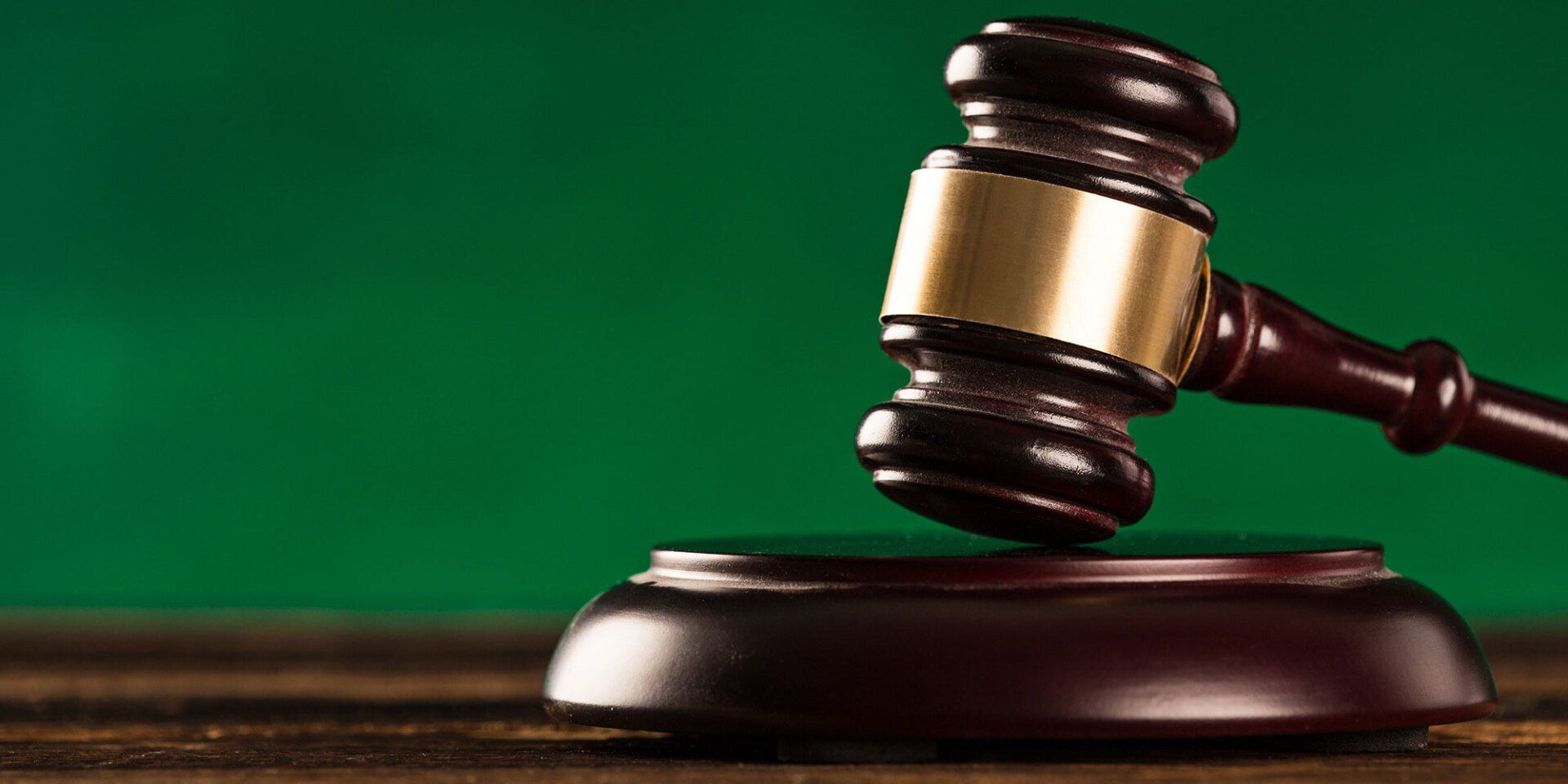 gavel in front of green background