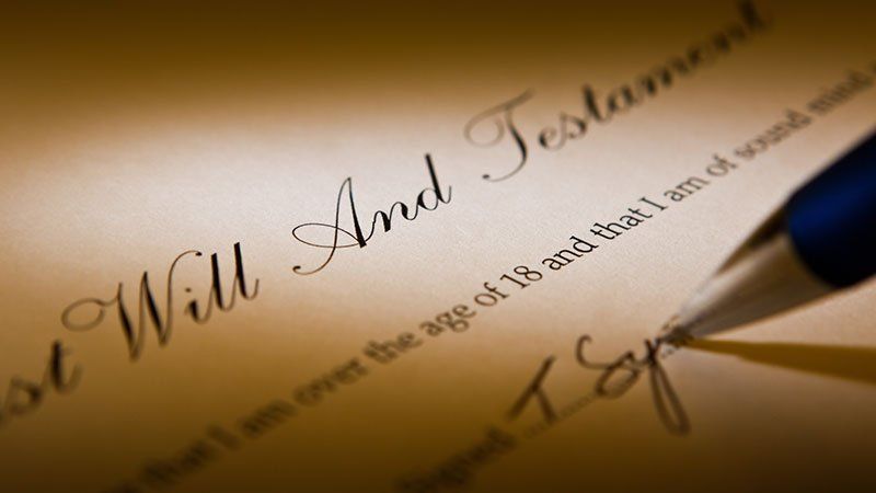 pen writing on a last will and testament