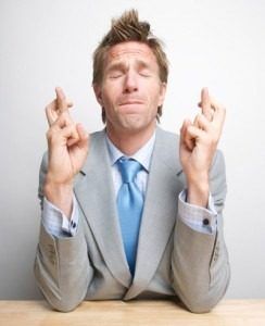 man crosses his fingers
