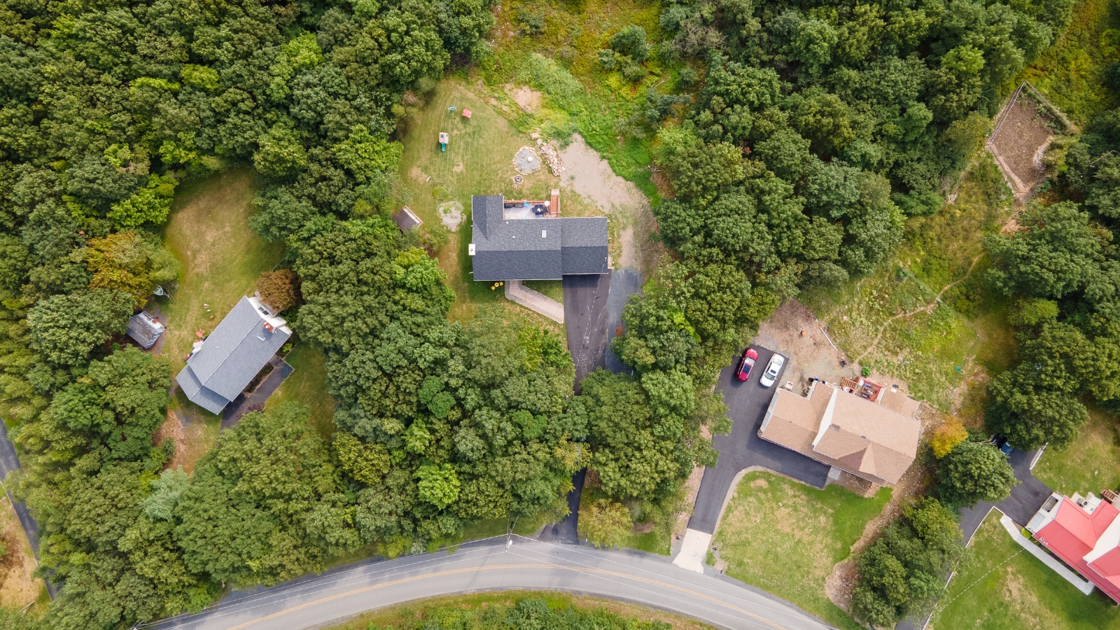 Aerial photo of homes in the woods by Pocono Drone Photography