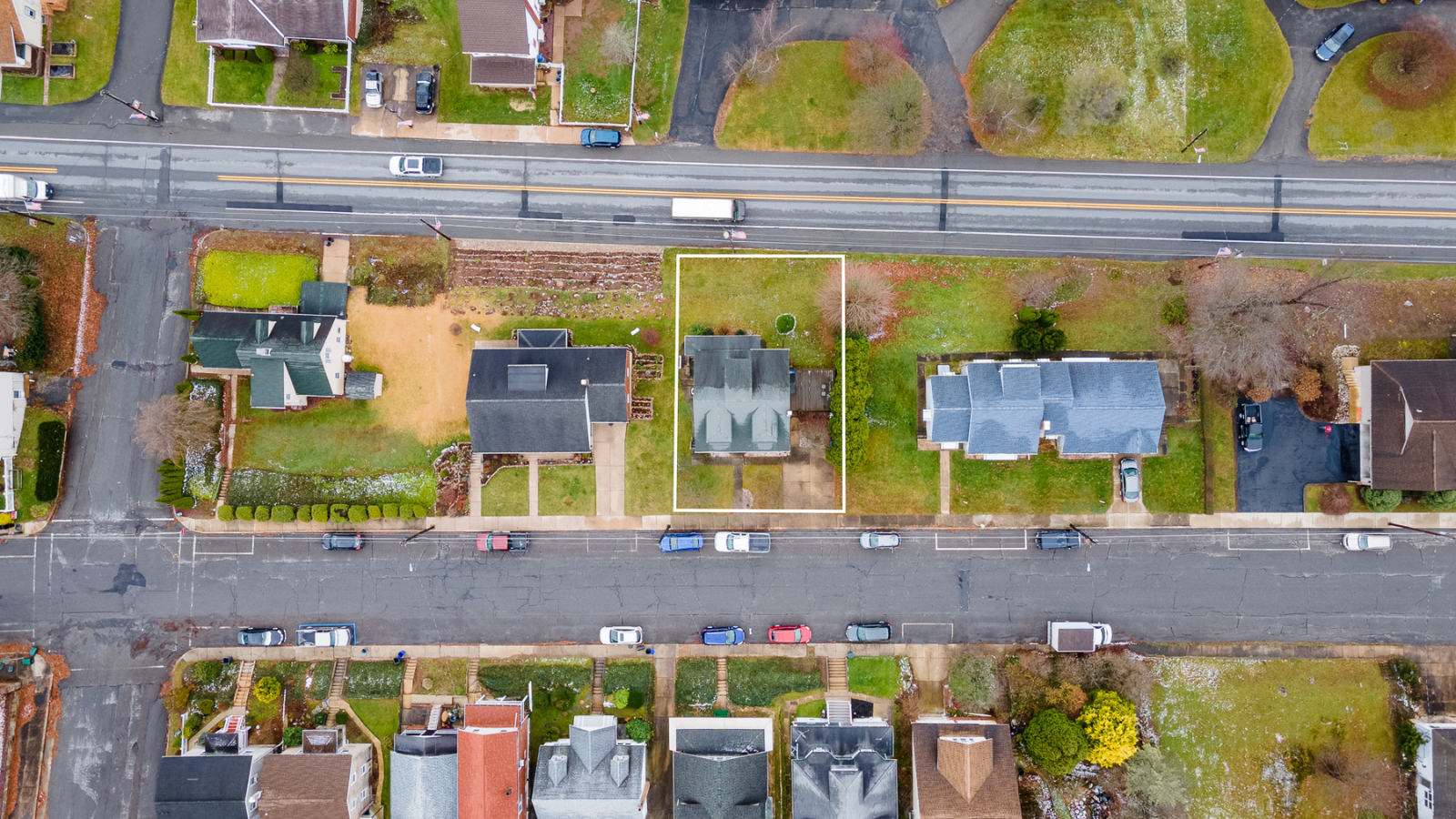 Aerial real estate photo of neighborhood with land outlined by Pocono Drone Photography