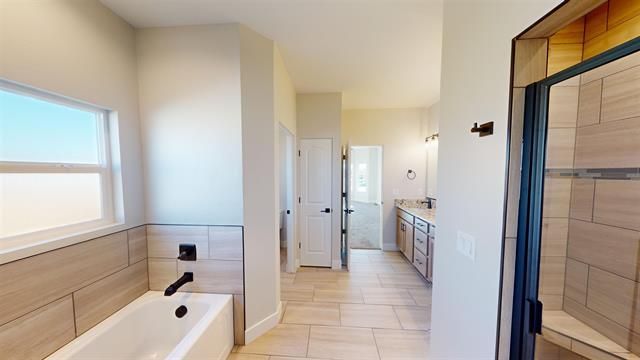 Full bathroom with tub and shower in The Silverado model.