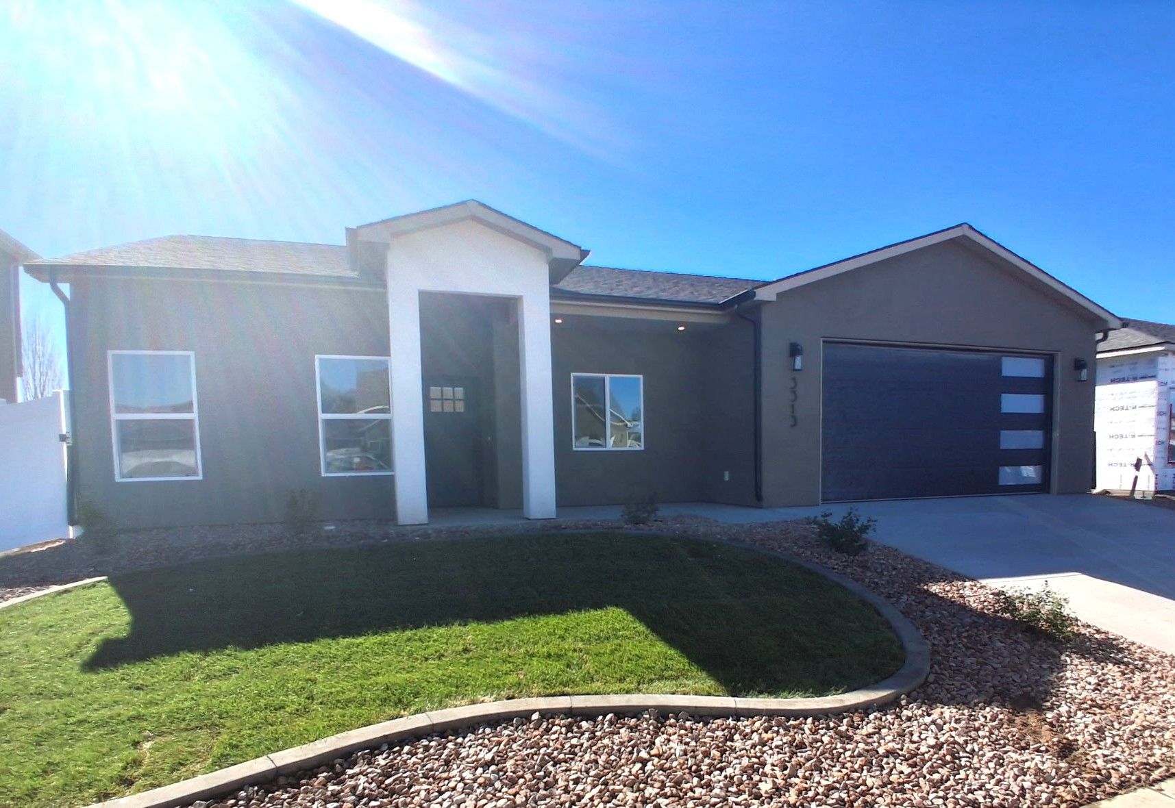 Modern new construction home with a black garage door for sale in Grand Junction, Colorado