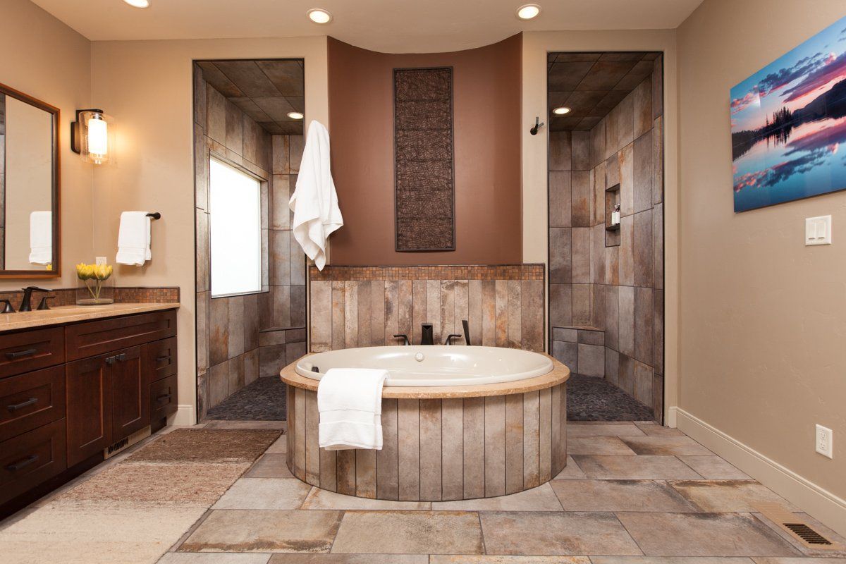 Modern bathroom interior featuring walk-in shower and circular tub