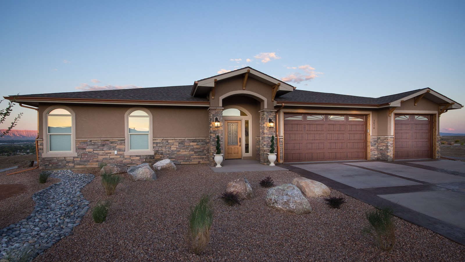 Contemporary house exterior with arched windows by Integrity Homes