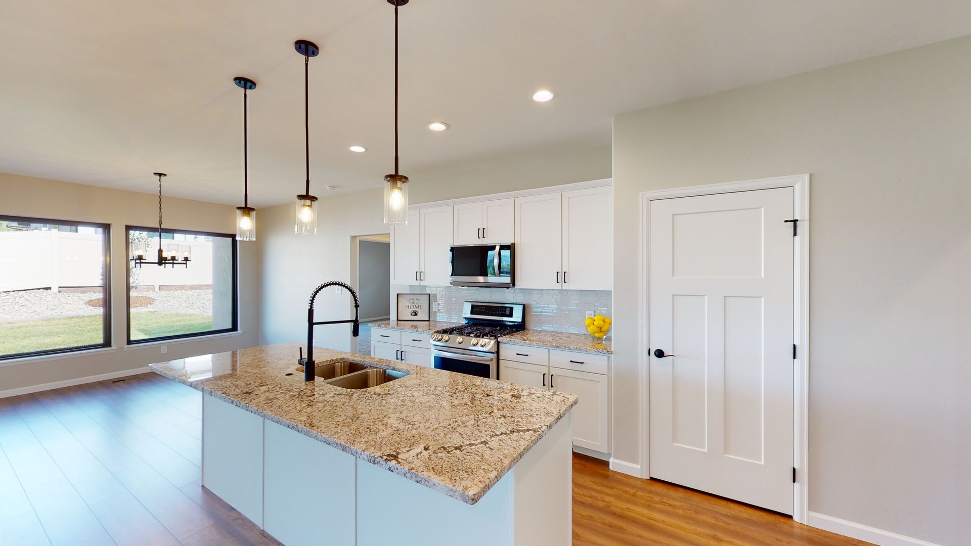 Sleek kitchen design featuring granite counters and hardwood floors