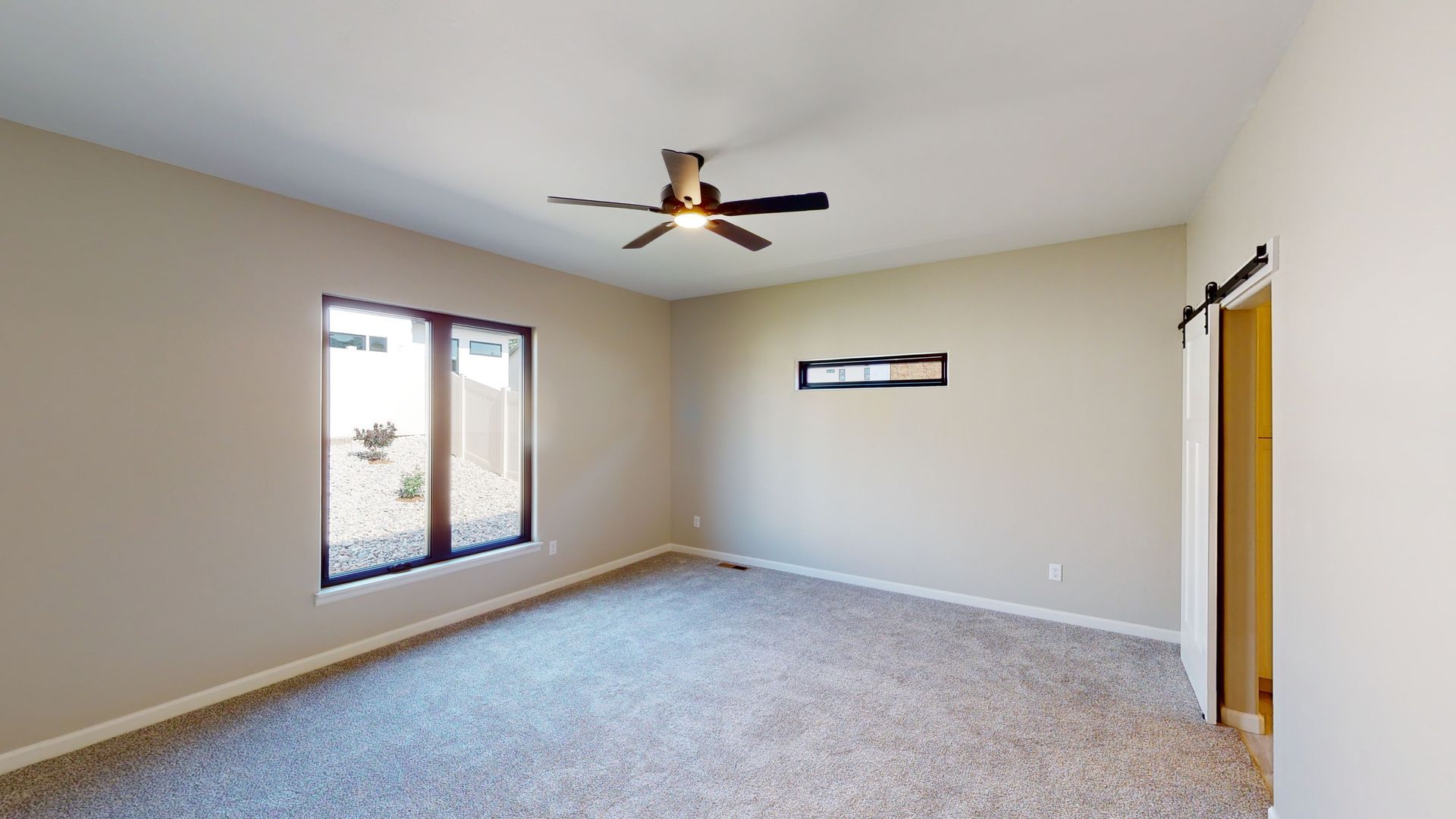 Spacious master bedroom with ceiling fan