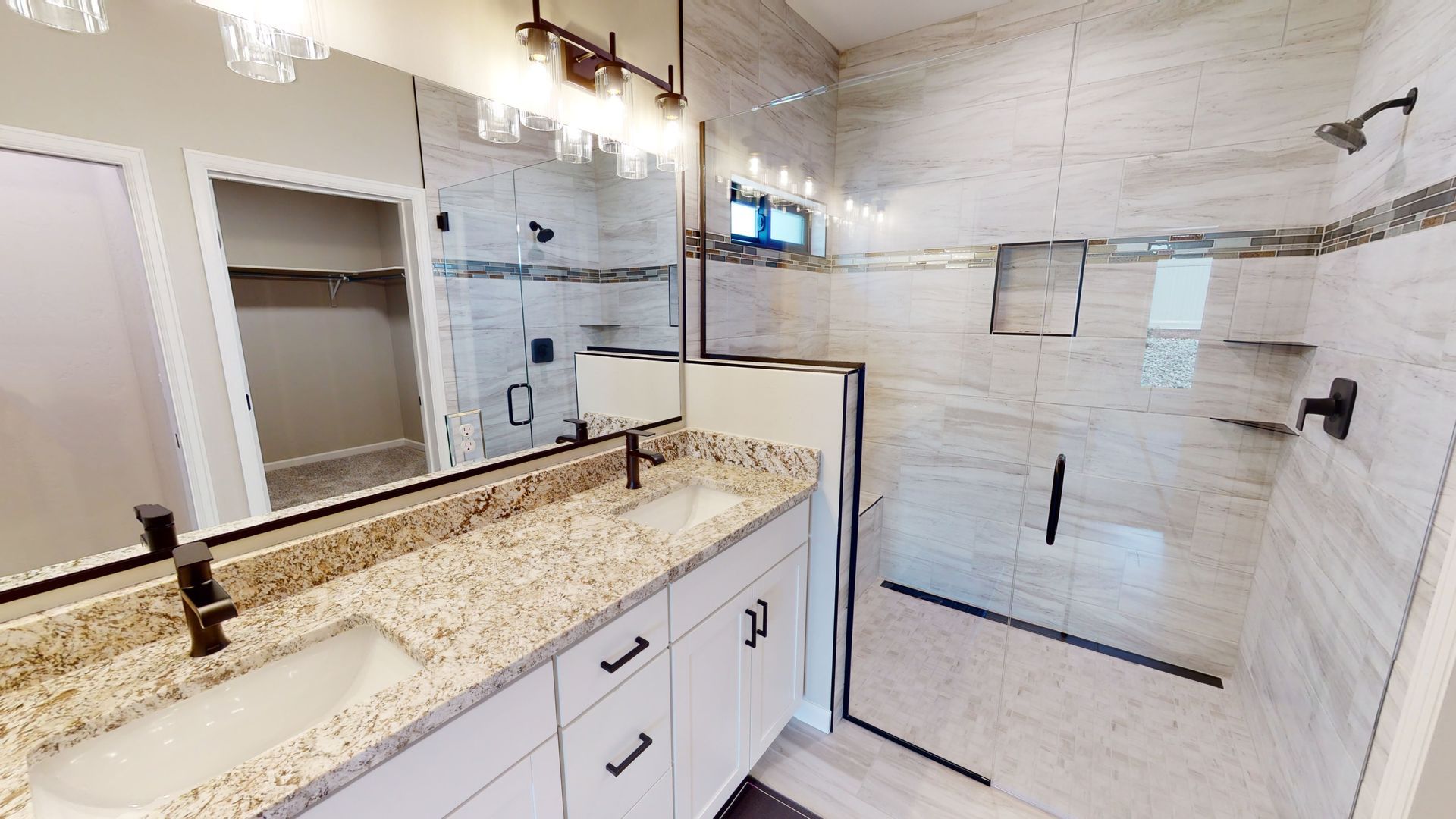 Contemporary bathroom design with double vanity and marble accents