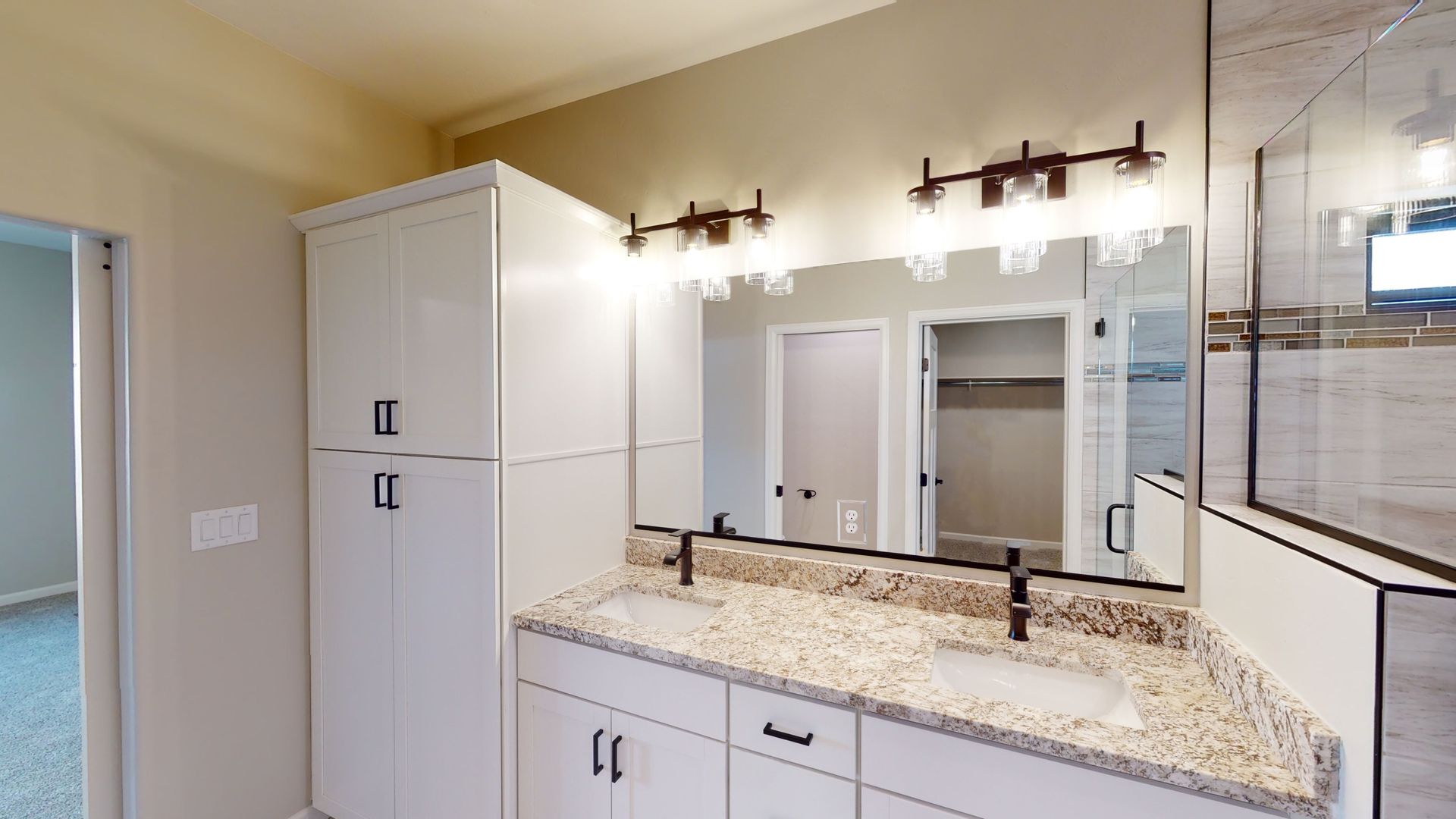 Contemporary bathroom design with double vanity and granite counters