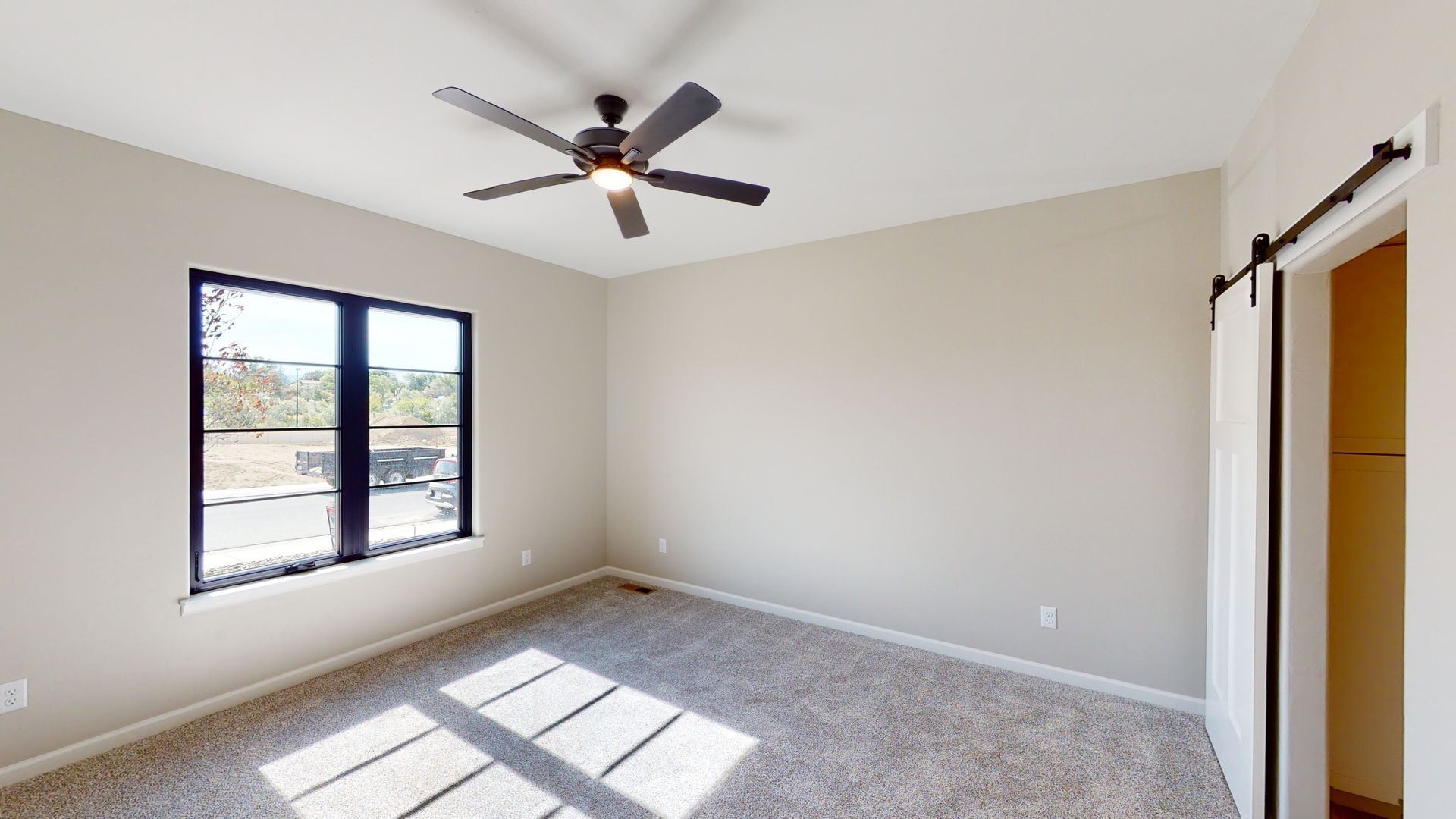 Cozy bedroom interior with plush carpeting and neutral decor