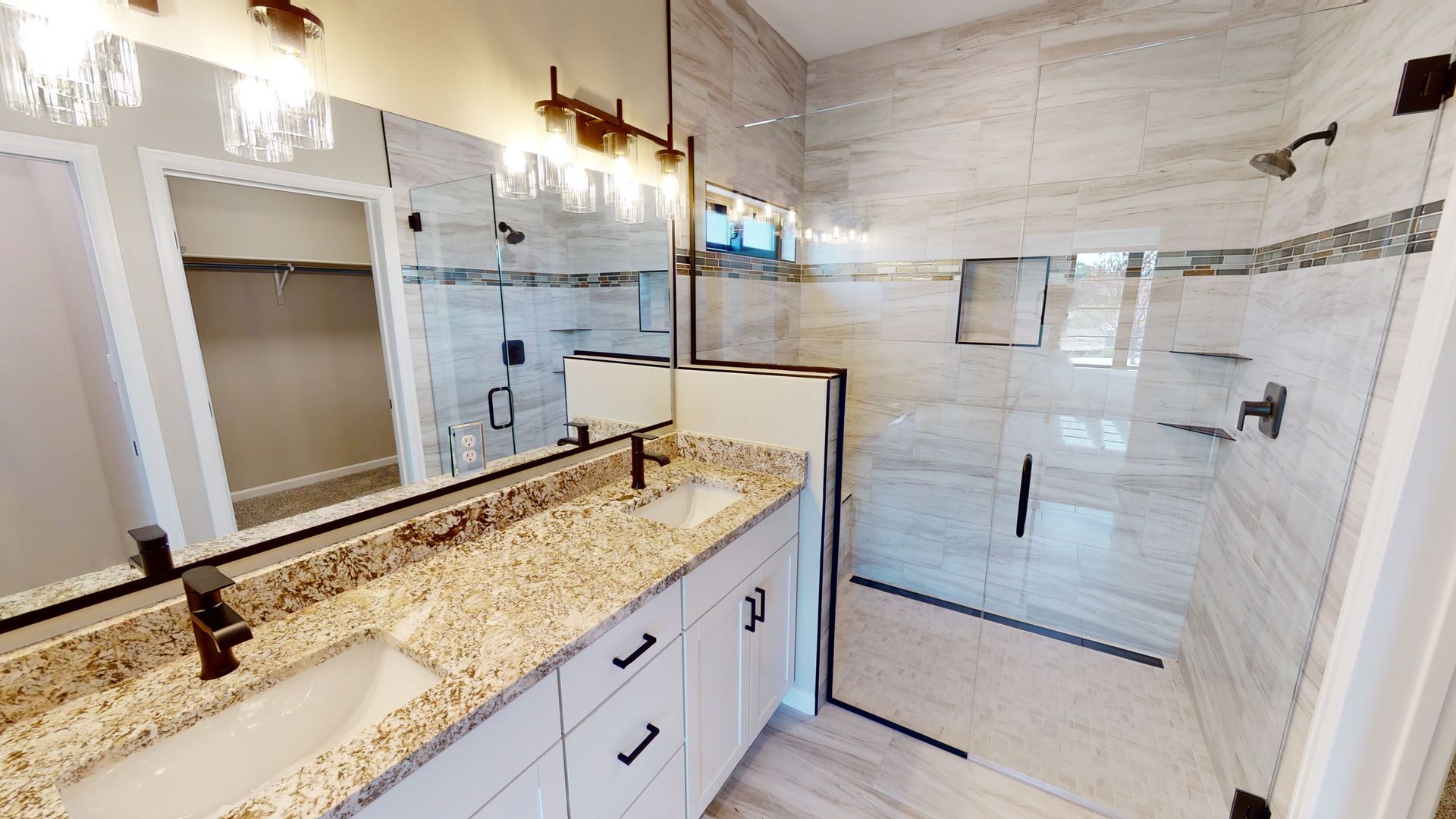 Contemporary bathroom design with double vanity and granite counters