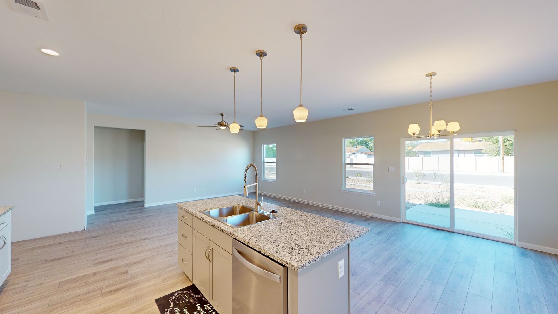 Great room with white kitchen with granite counter tops