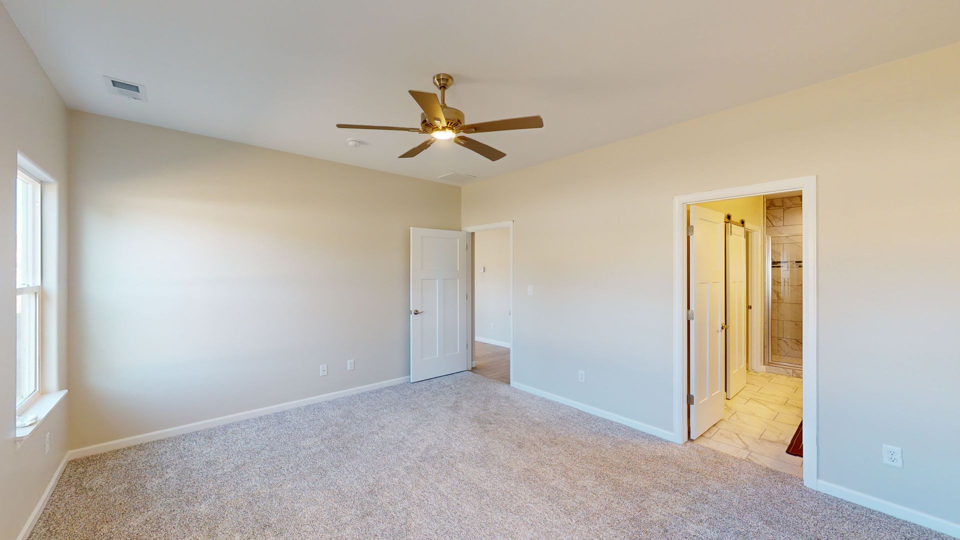 Spacious master bedroom with ceiling fan