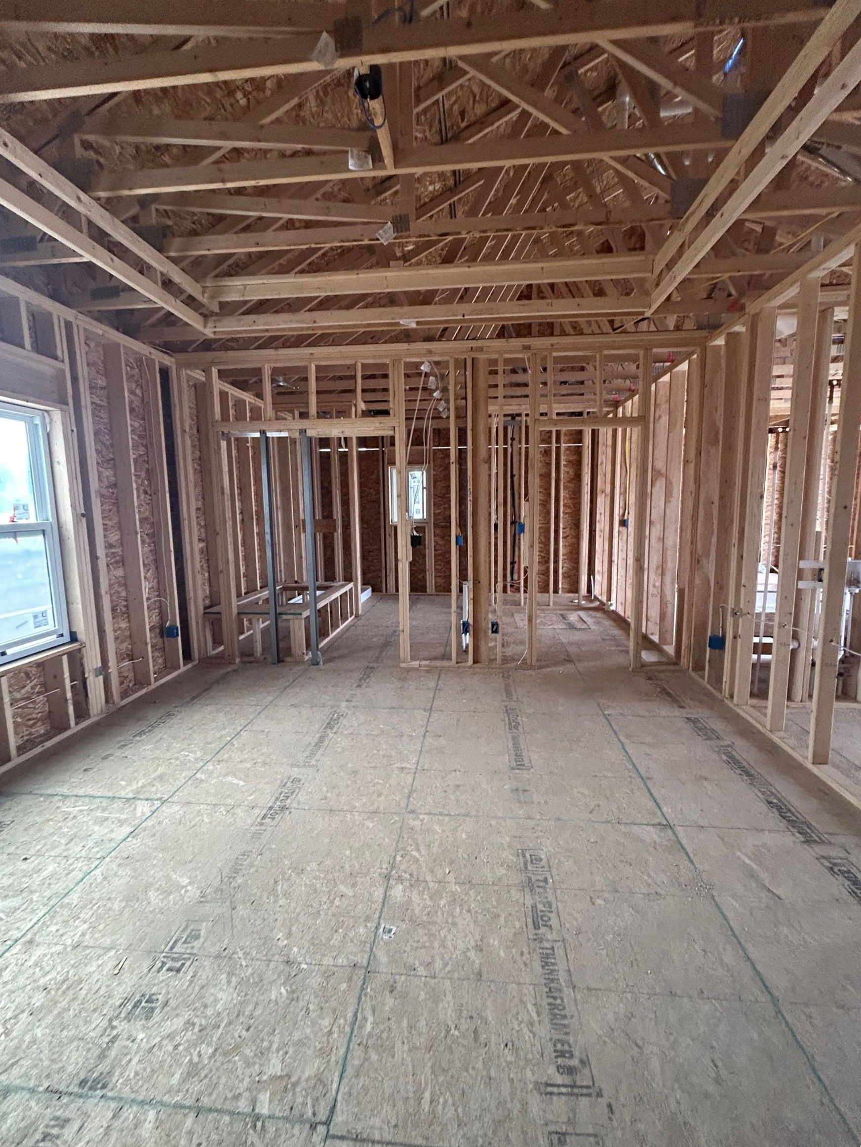 Open concept living area with high ceilings in the new home.