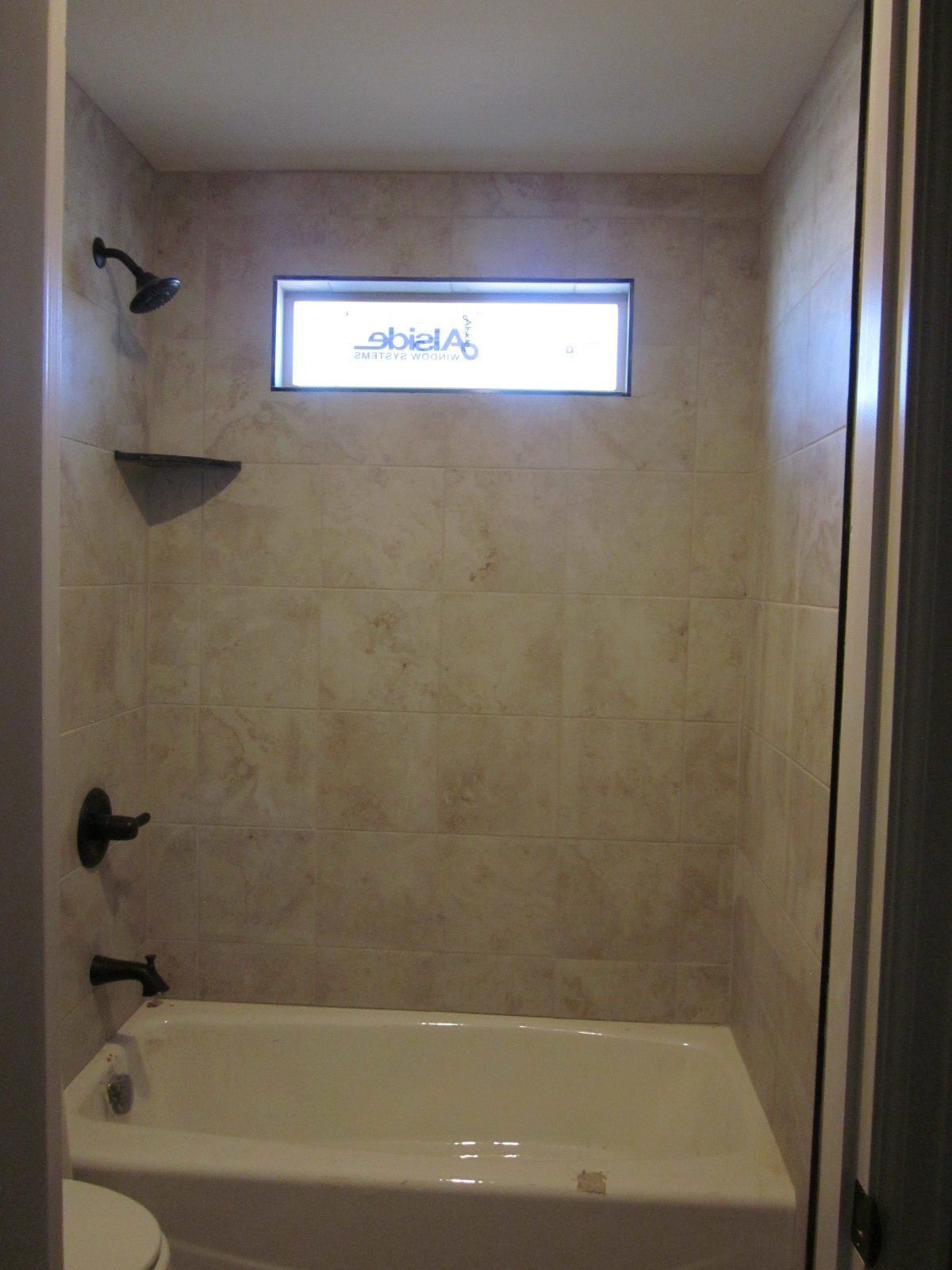 Tiled Shower and Tub Combo with Window Above | Integrity Homes | Grand Junction, CO 81501