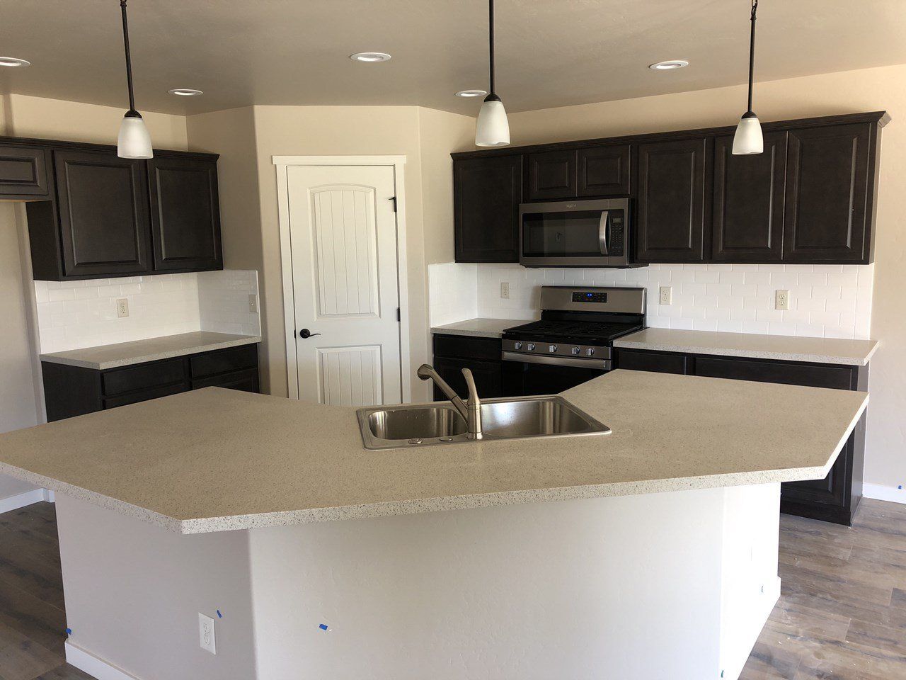 Kitchen with Stainless Steel Appliances and Island with a Sink and Seating | Integrity Homes | Grand Junction, CO 81501