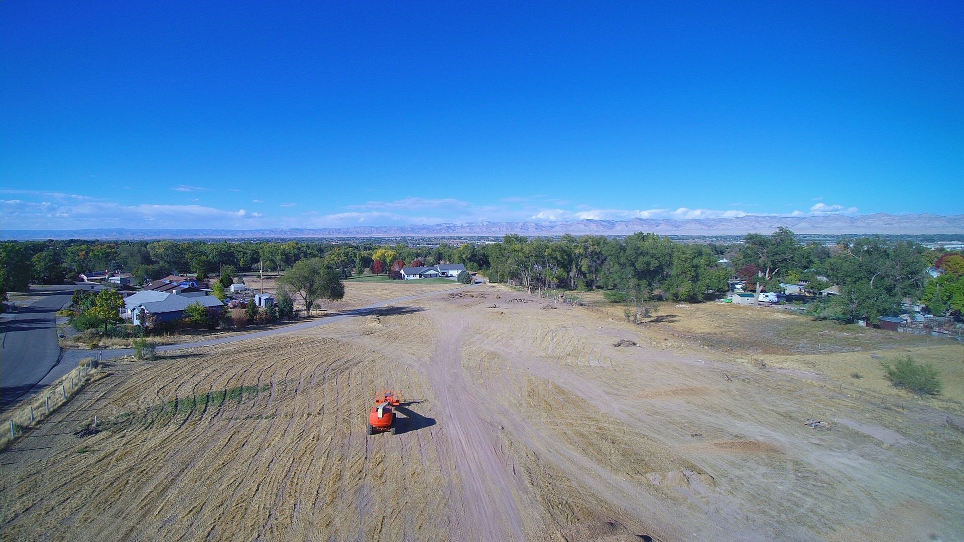 View of an upcoming street in Monument Ridge Estates with utilities and curbs installed.
