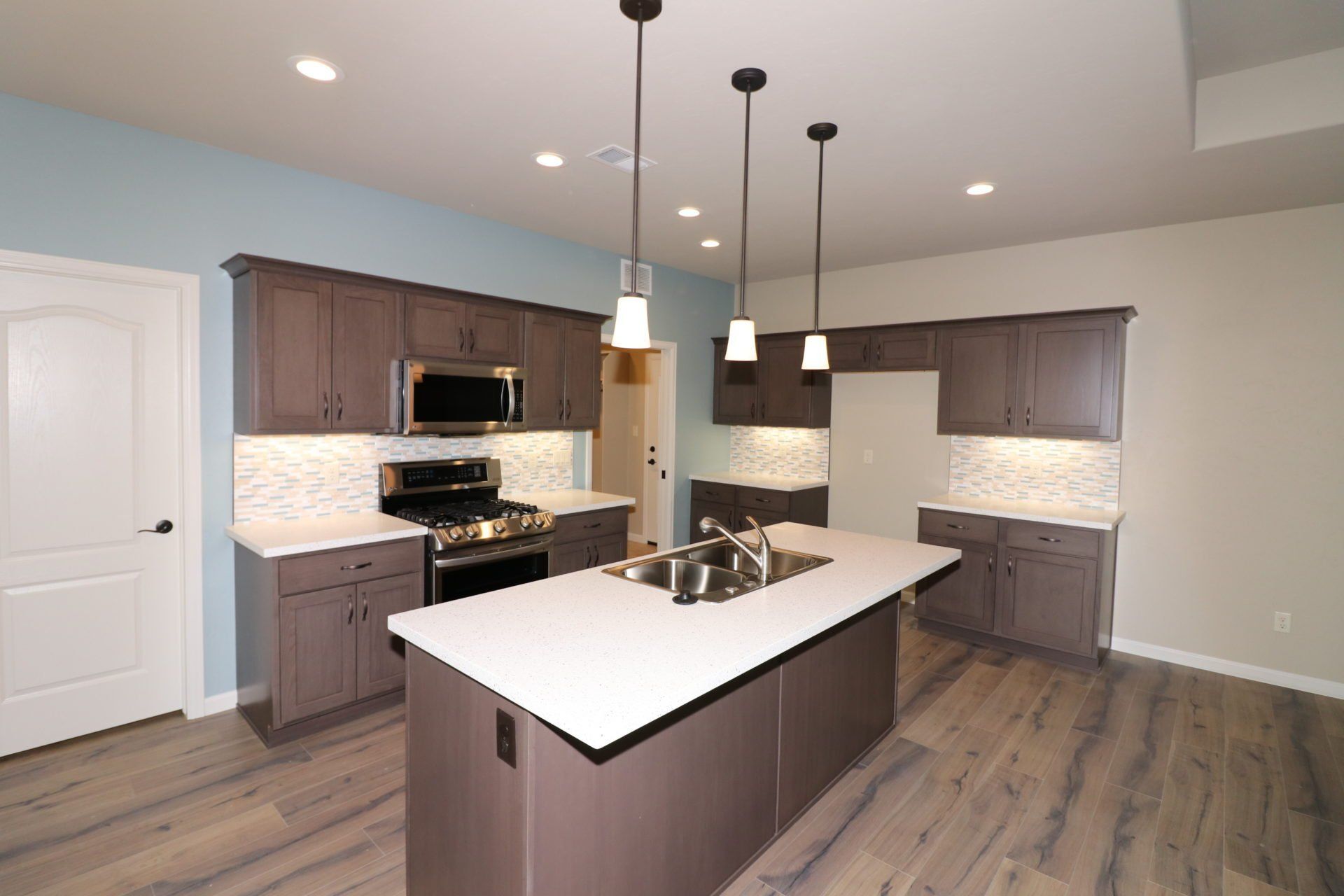 Kitchen with wood cabinets, quarts counters and stainless steel range