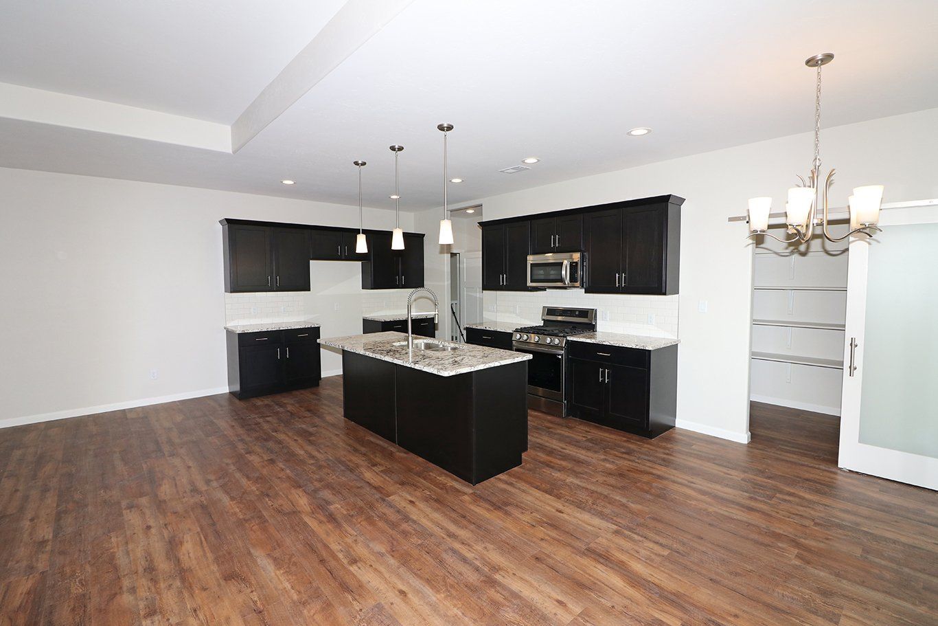 Contemporary kitchen layout with open concept design by Integrity Homes