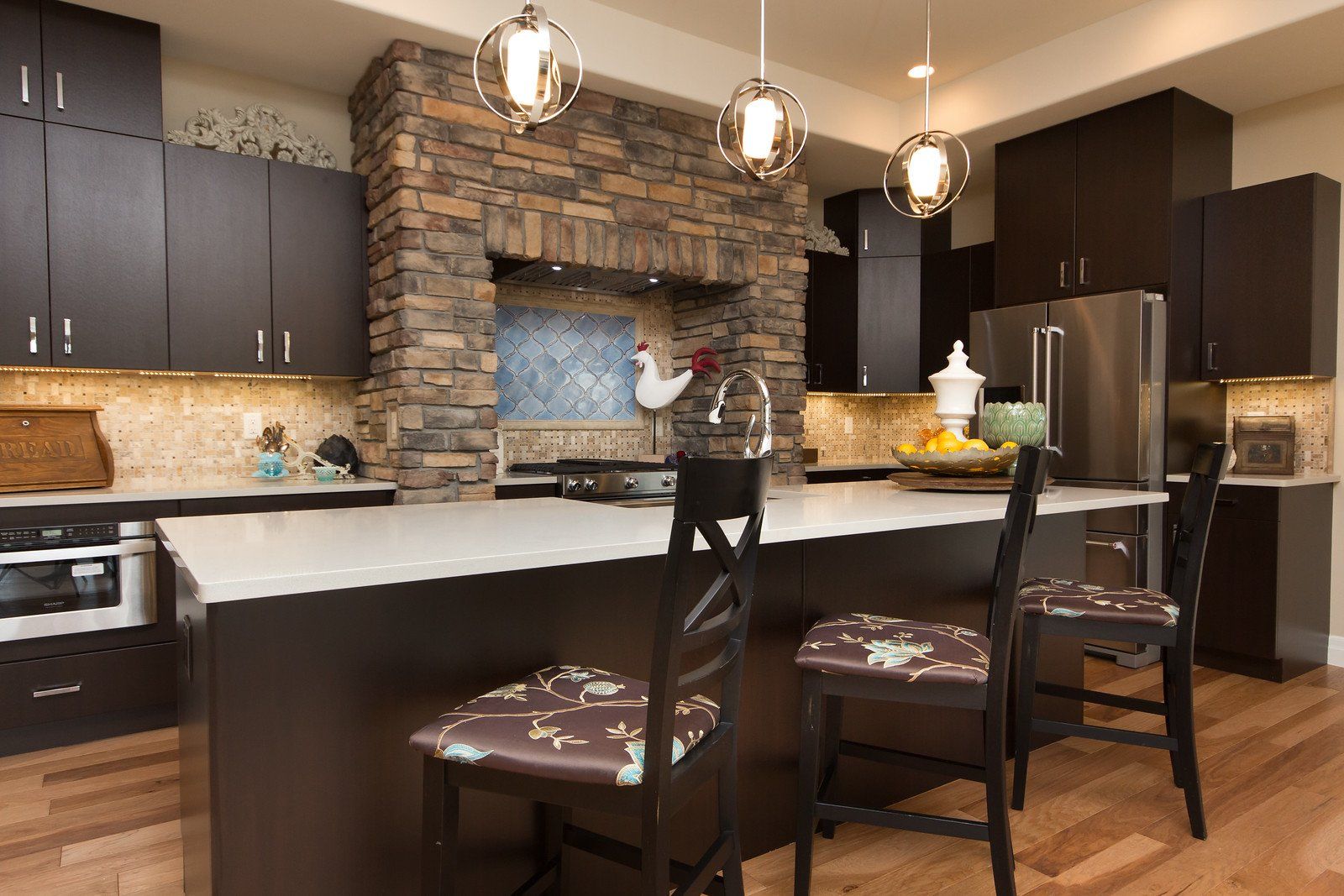Kitchen with Brick Range Hood and Island with Seating | Integrity Homes | Grand Junction, CO 81501
