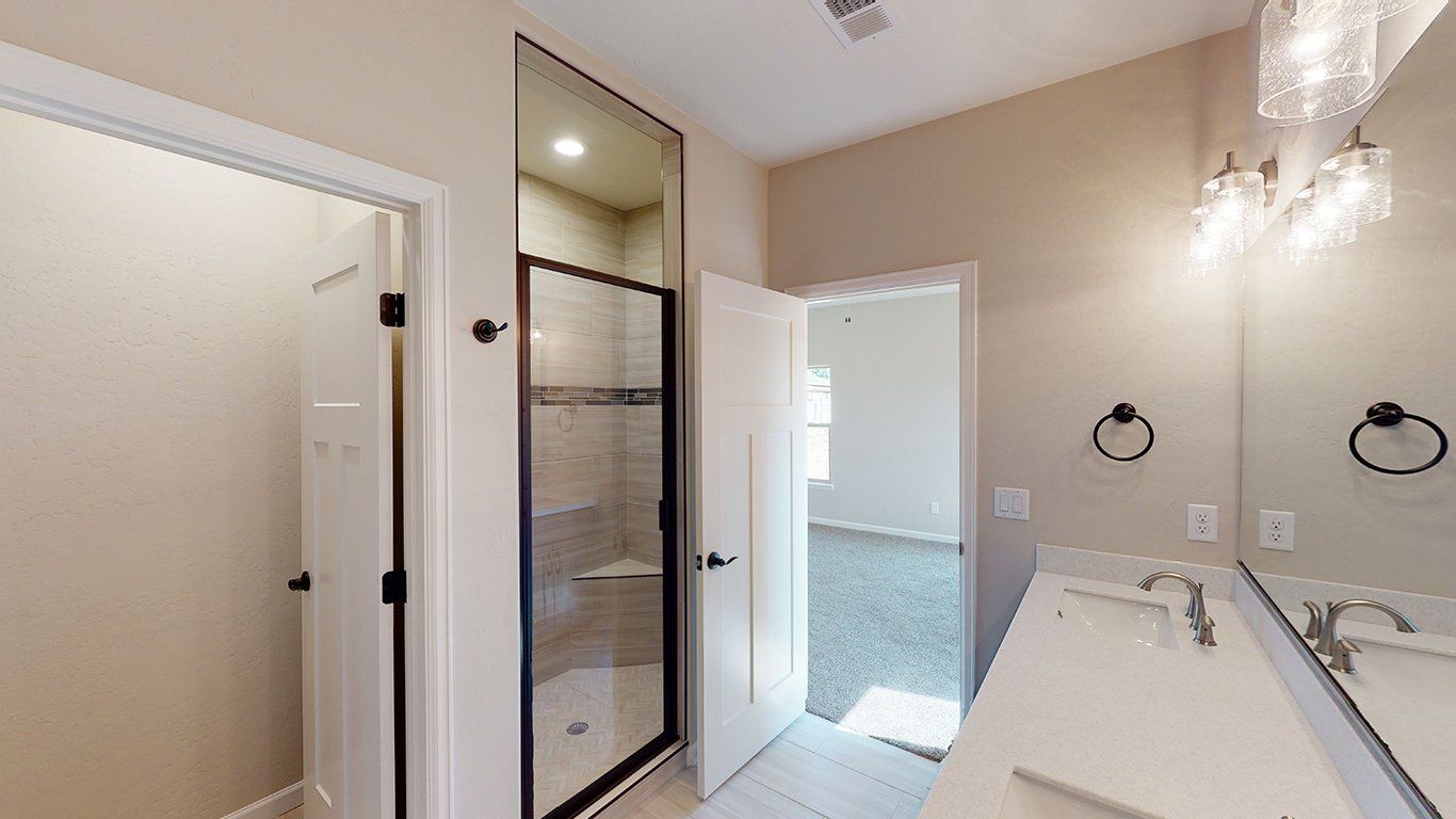 Toilet Room and Tile Shower with Built-In Bench and Glass Door | Integrity Homes | Grand Junction, CO 81501
