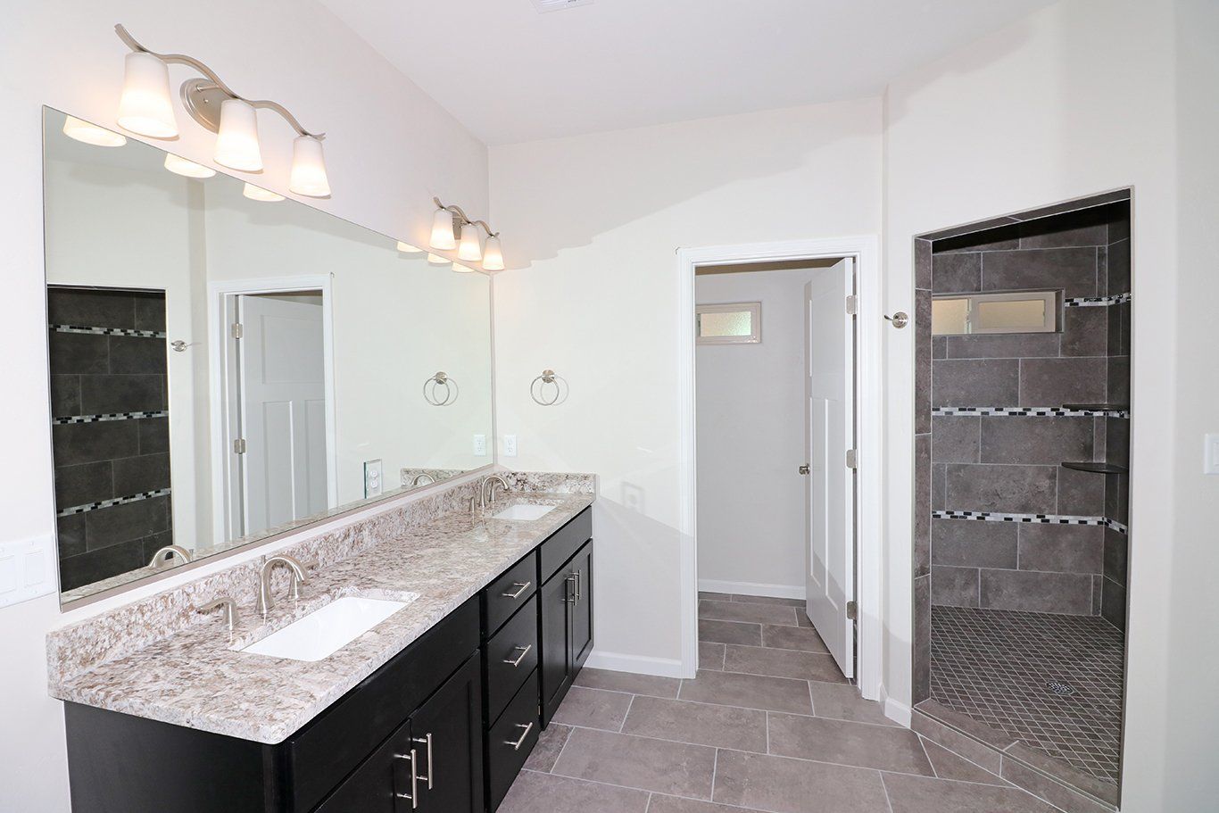 Bathroom was double sink vanity and walk-in shower and granite counters.