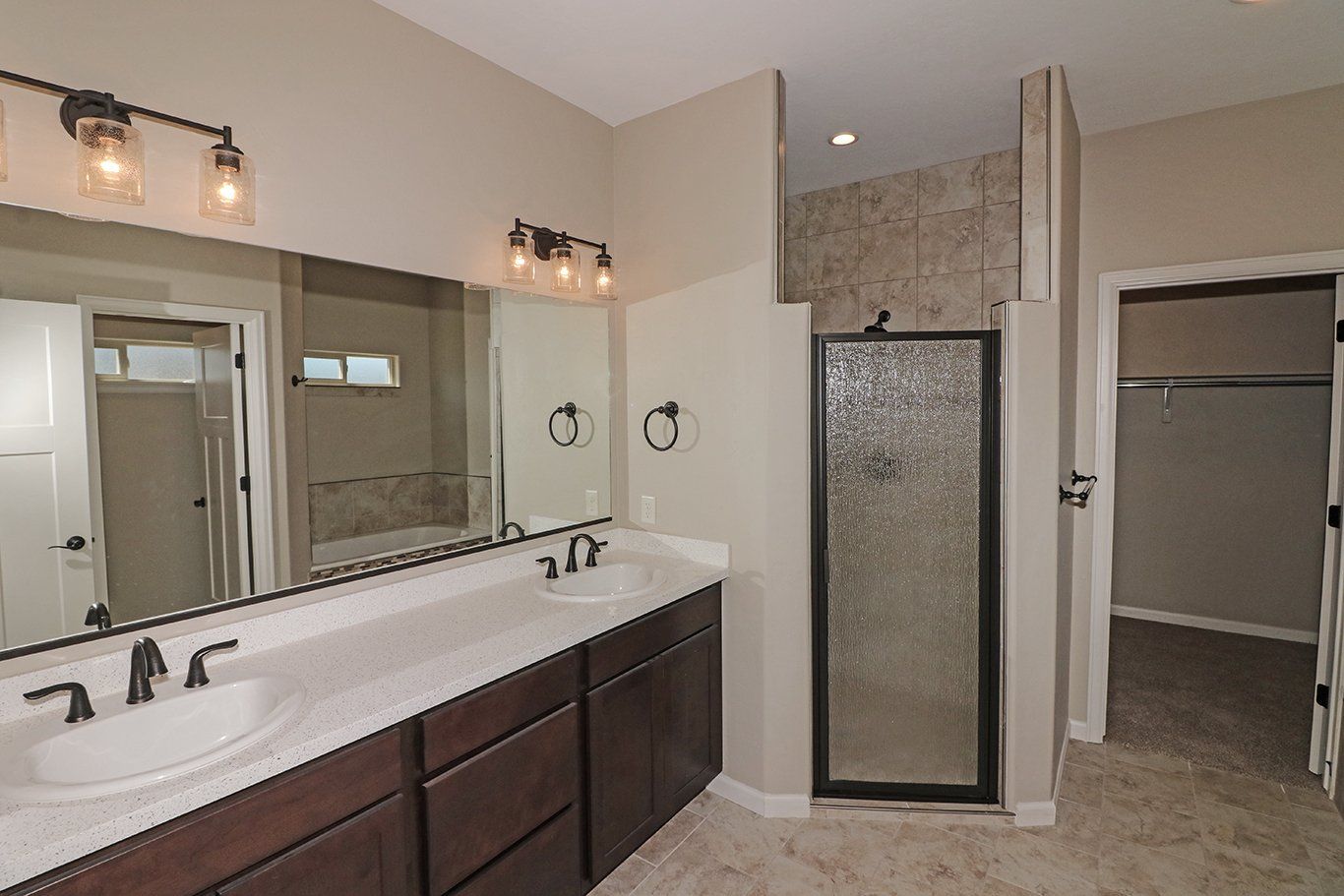 Ensuite Primary Bathroom with Double Vanity and Tile Shower | Integrity Homes | Grand Junction, CO 81501