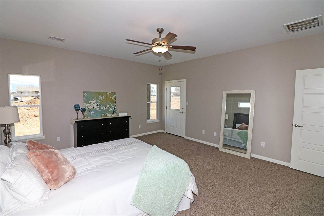 Primary Bedroom with Ceiling Fan and Patio Access | Integrity Homes | Grand Junction, CO 81501