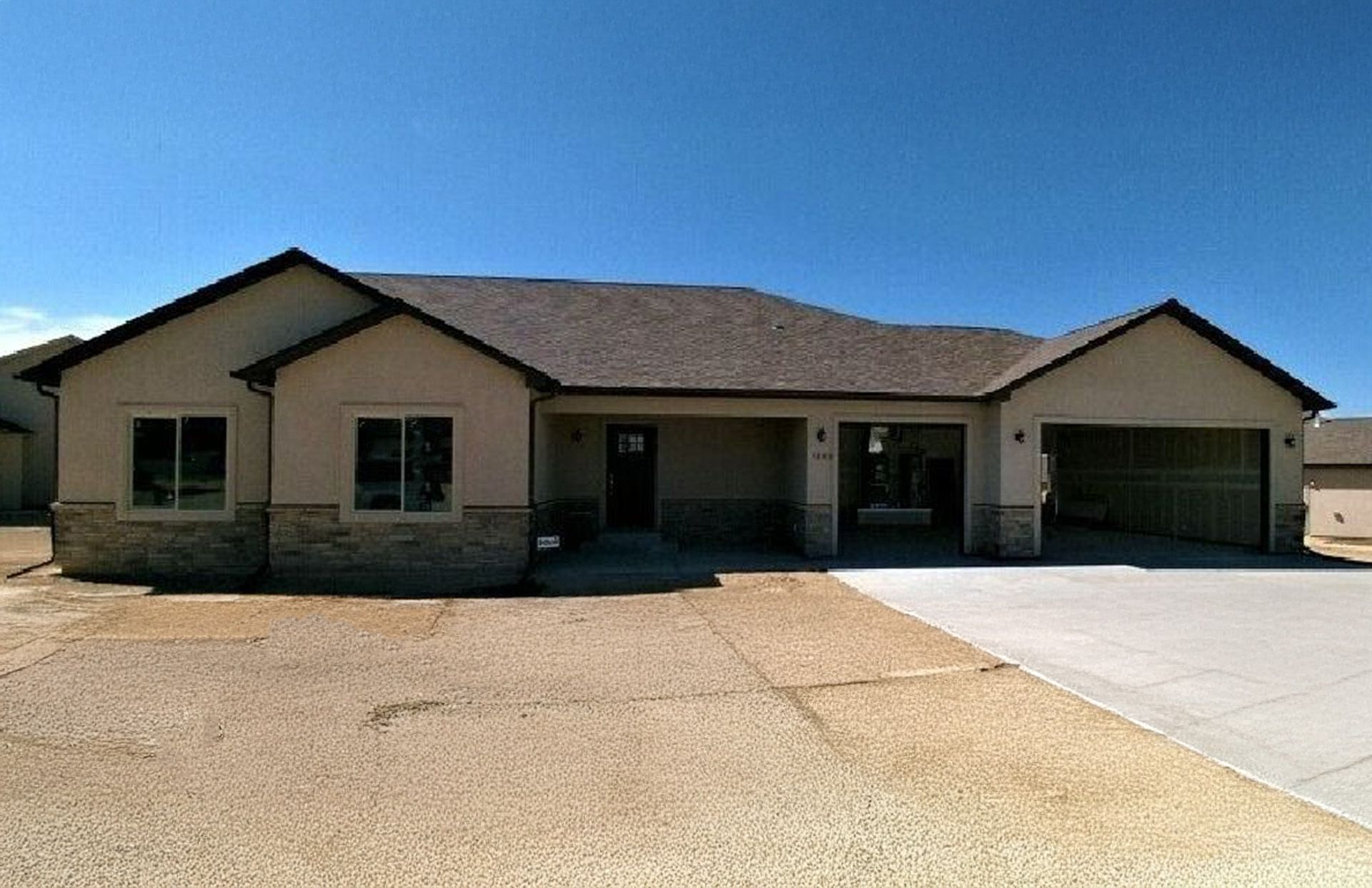 The Oak model home exterior with a dark roof and light siding.