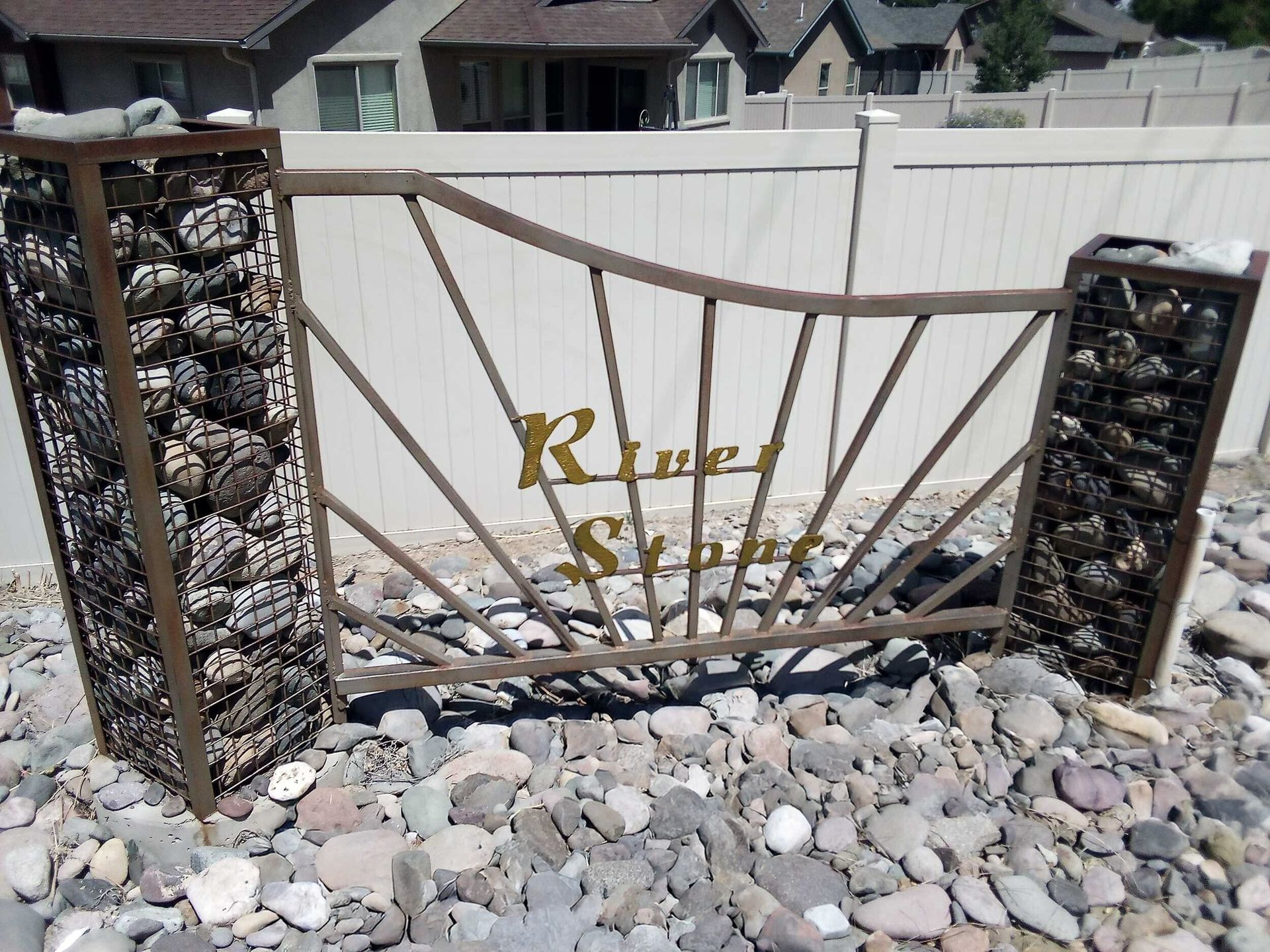 River Stone subdivision entrance sign with mountain views in the background.