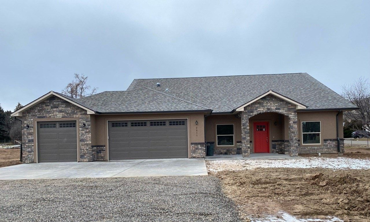 3 car garage stone and stucco exterior home built by Integrity Homes