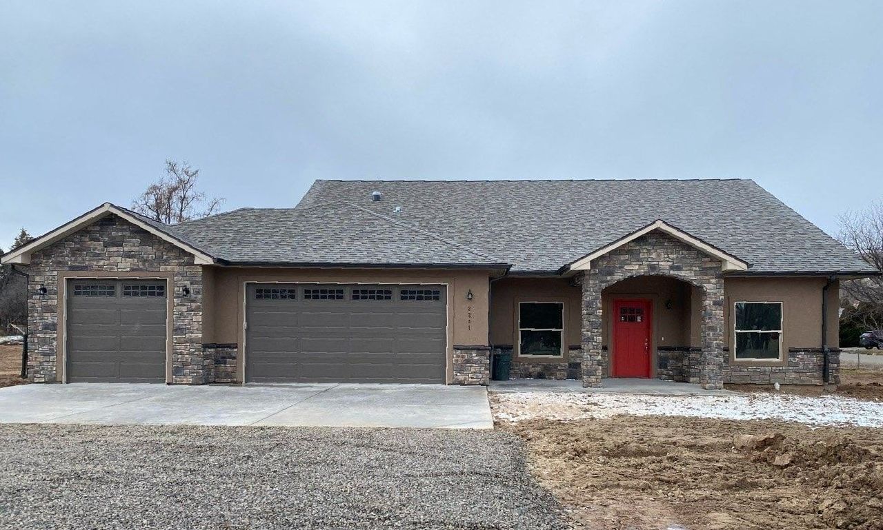 3 car garage stone and stucco exterior home built by Integrity Homes