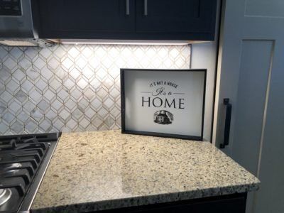 Designer kitchen interior with custom tile backsplash and gas range