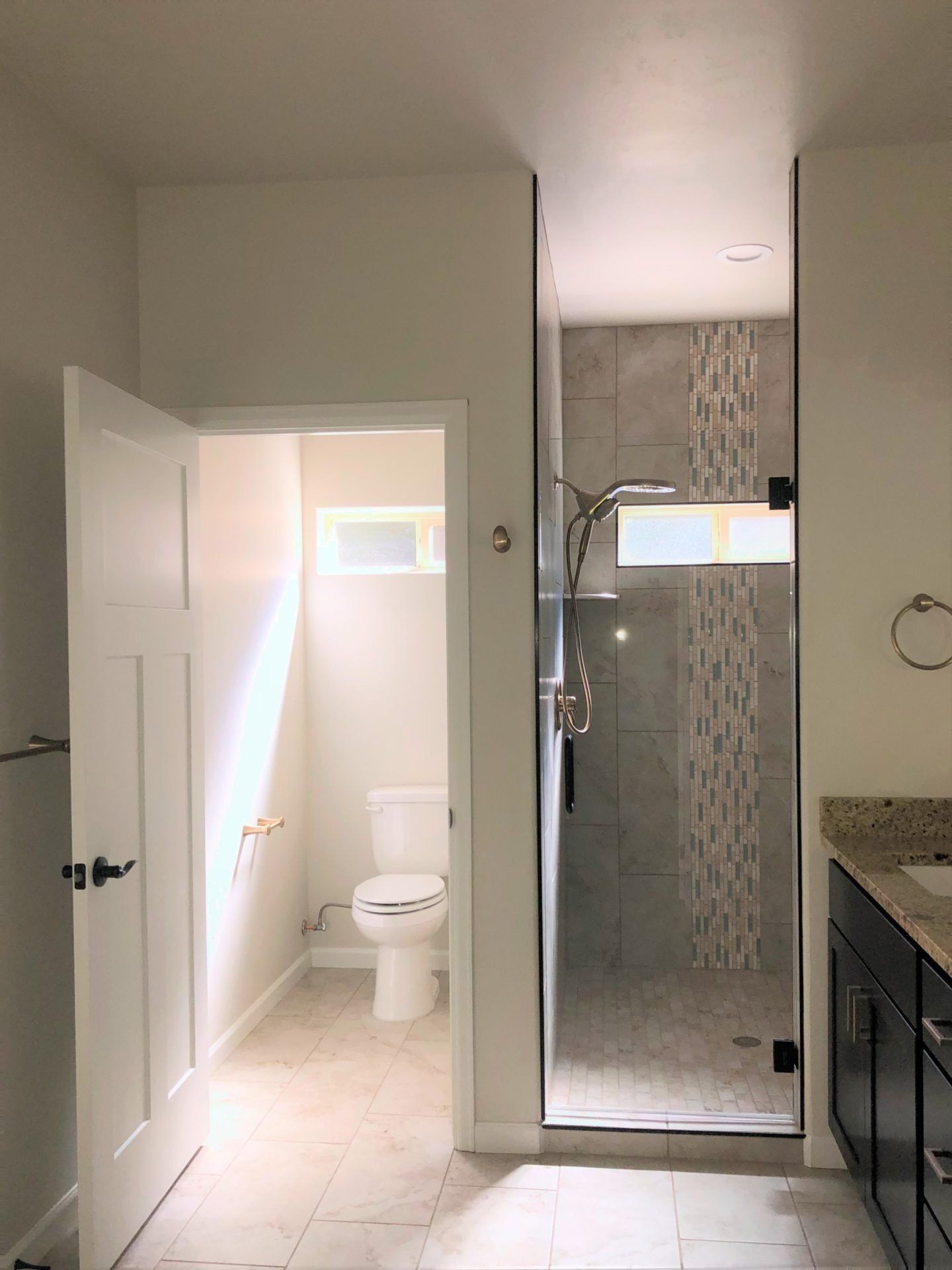 Toilet Room Next to Walk-In Tile Shower with Glass Door | Integrity Homes | Grand Junction, CO 81501